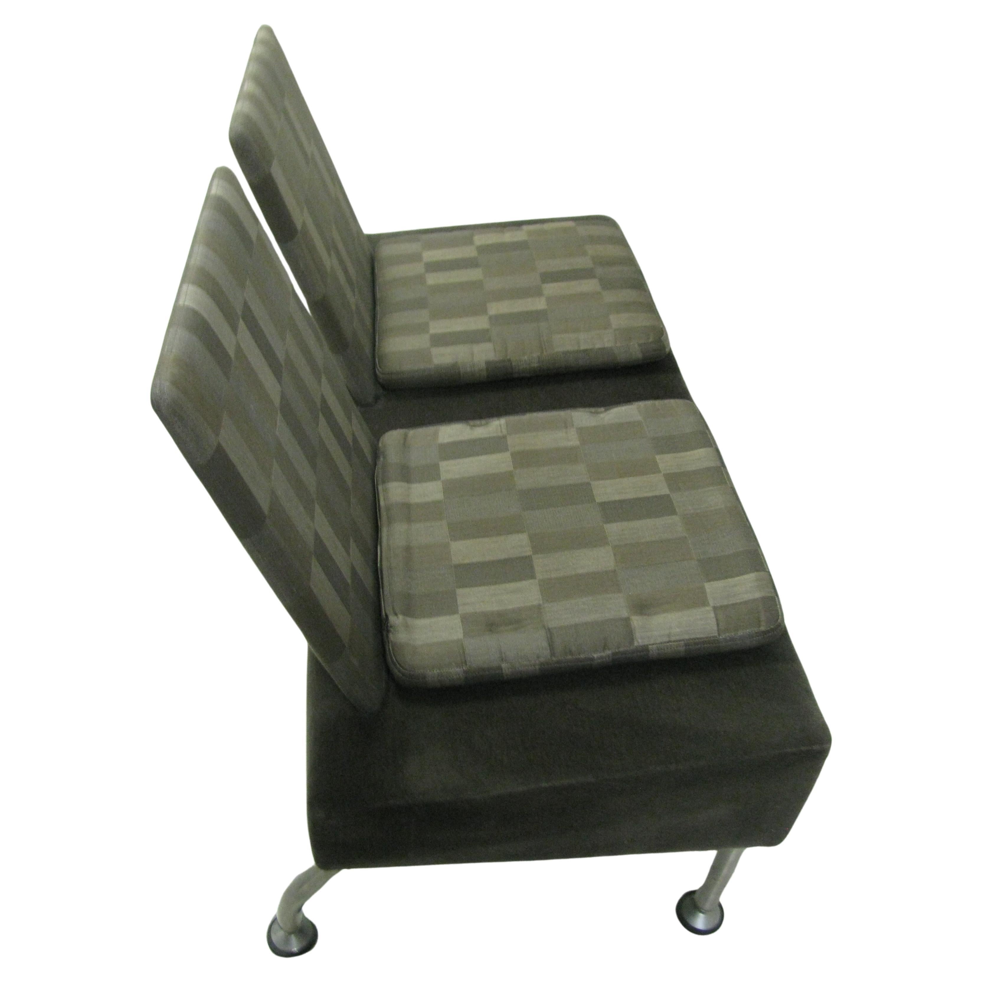 Sleek, simple and well constructed. Base is covered in gray cotton velvet. Seat backs and cushion pads in a gray checker board. Stainless steel legs. Heavy duty construction possibly by Steel case. High quality.