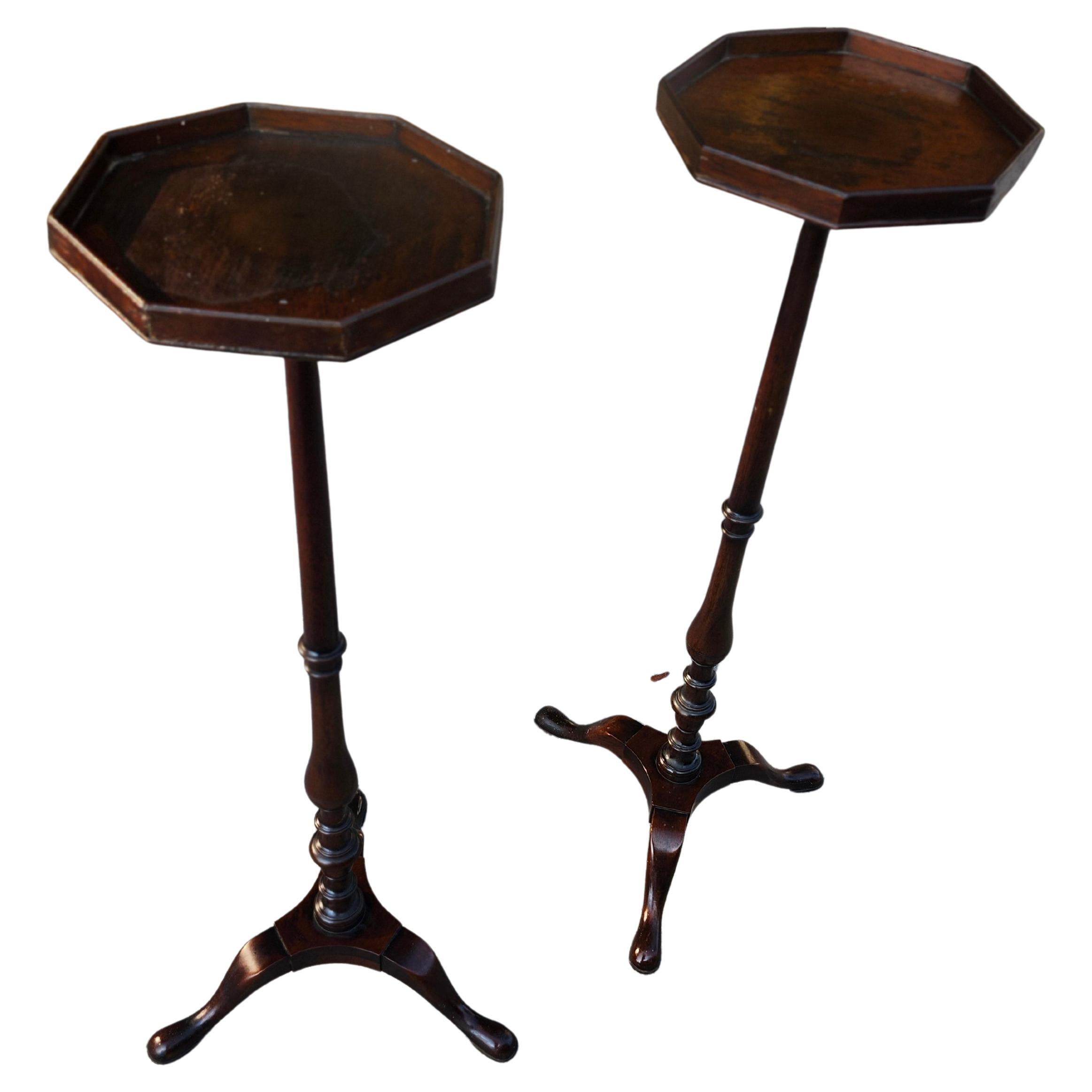 Fabulous pair of tall mahogany plant stands by Kittinger, tagged on underside. Turned posts come up to a octagon top with splayed pad feet. Tops show staining from use which is surface only.  Excellent craftsmanship with dovetail joinery at the