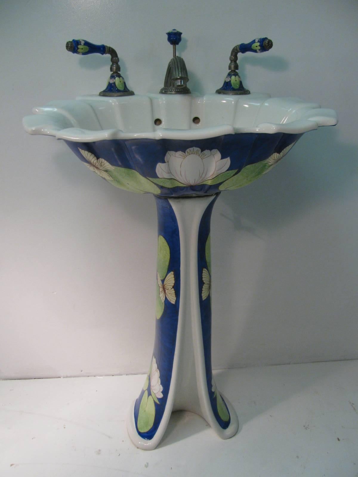Beautiful and elegant porcelain pedestal sink by Sherle Wagner. Hand-painted in Italy which includes the faucet set, soap holder, toilet paper holder and two robe hooks. All are in the bronze finish. All in excellent condition with no chips to the