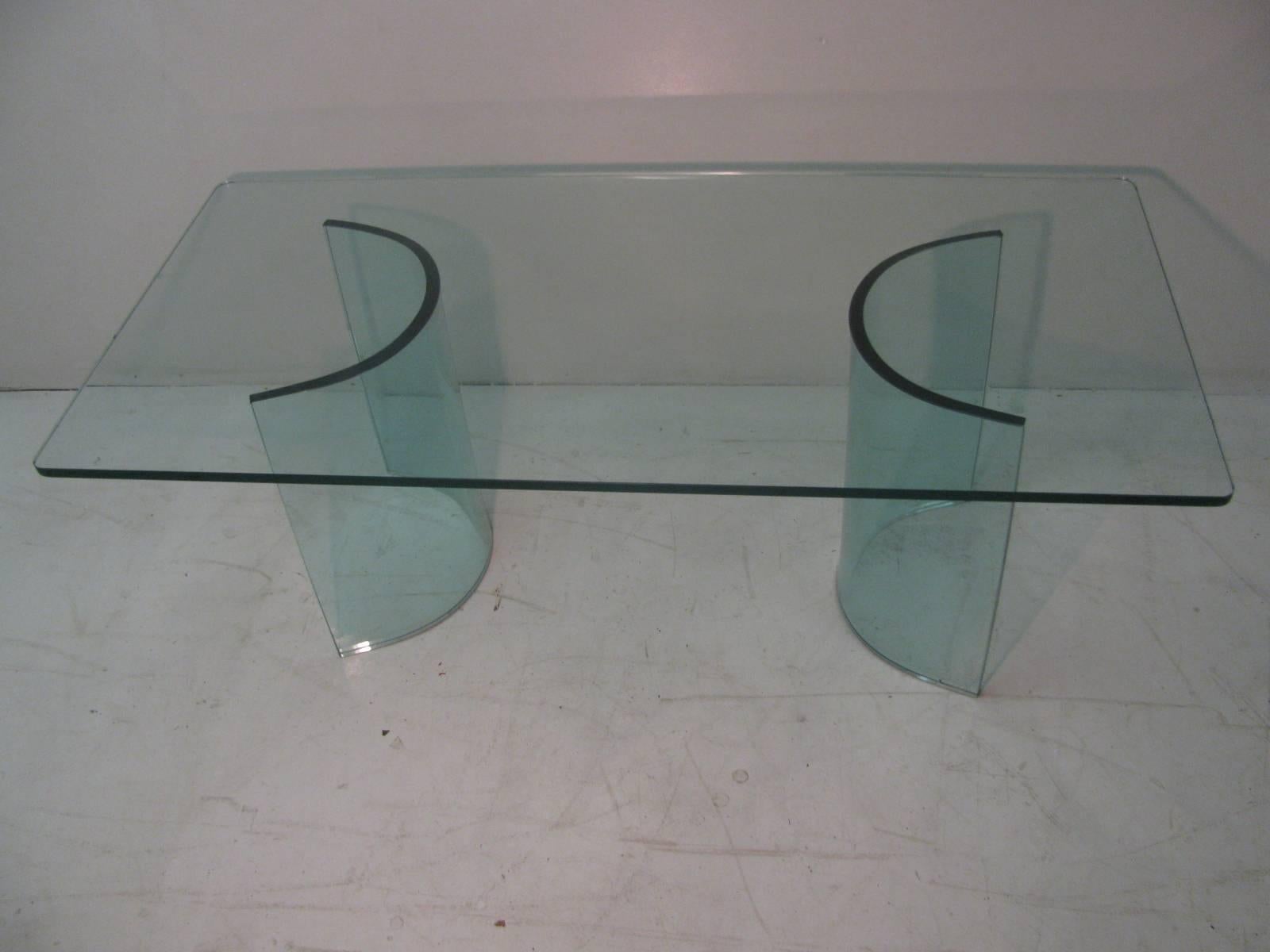 Simple and elegant Italian all glass cocktail table with curved glass panels supporting the rectangular glass top. Inspired by Fontana Arte.
