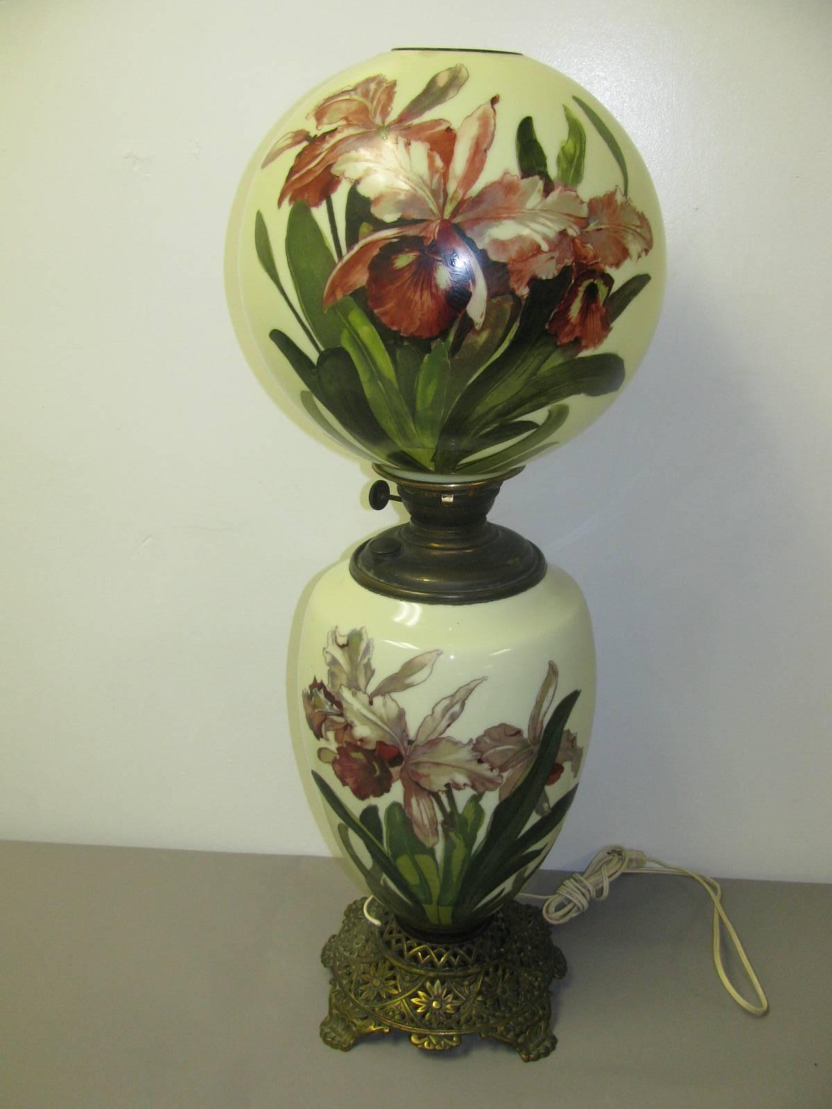 Fabulous and large, 33 inches tall, all original with the exception of being electrified. Beautifully hand-painted floral scene on both top and bottom glass shades.