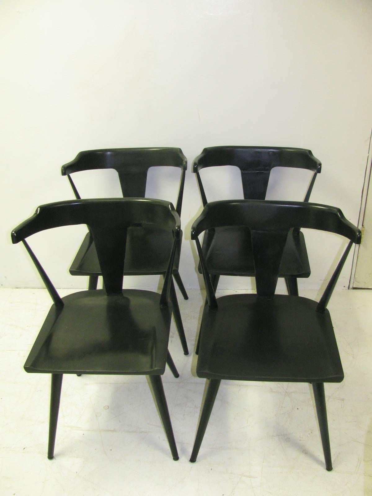 Set of four dining room chairs in black enamel by Paul McCobb for Winchendon. Chairs are labeled underneath the seat. In very good ,tight condition and have been recently recoated.
