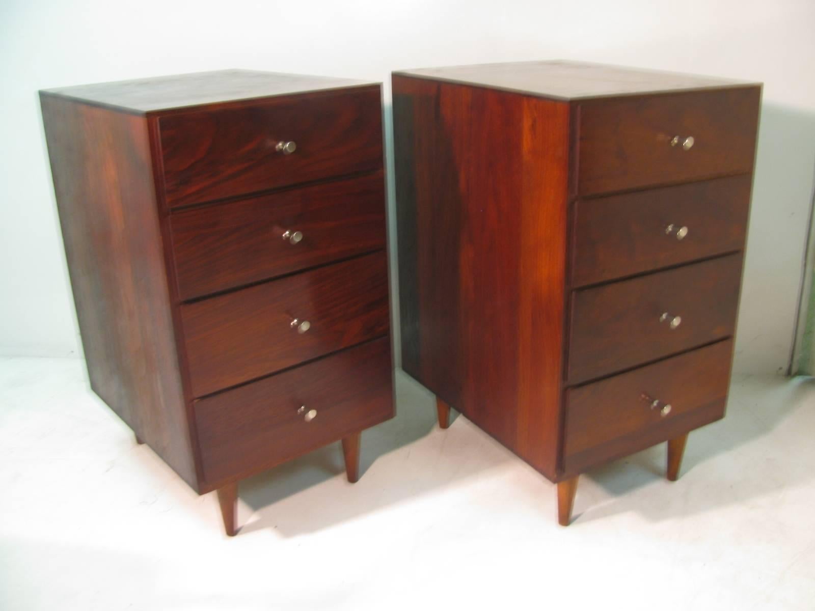 Simple and elegant pair of  three-drawer night tables in solid walnut with McCobb hour glass nickel pulls. Very tight and solid furniture. Masonite draw bottoms. Two drawers over one double size drawer on each table. Very good condition with a good