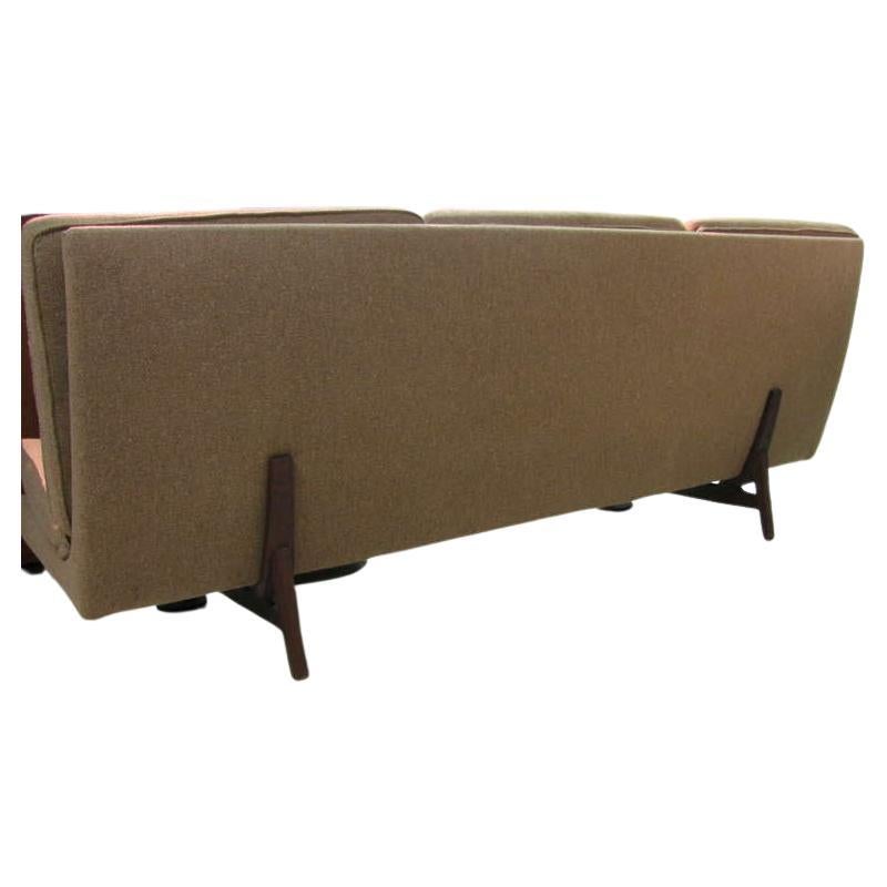 Beautiful and sleek Danish modern sofa. Armless sofa creates numerous possibilities. Teak legs cradle and support in the manner of less is more. Fabric is a wool tweed blend which is in good condition.