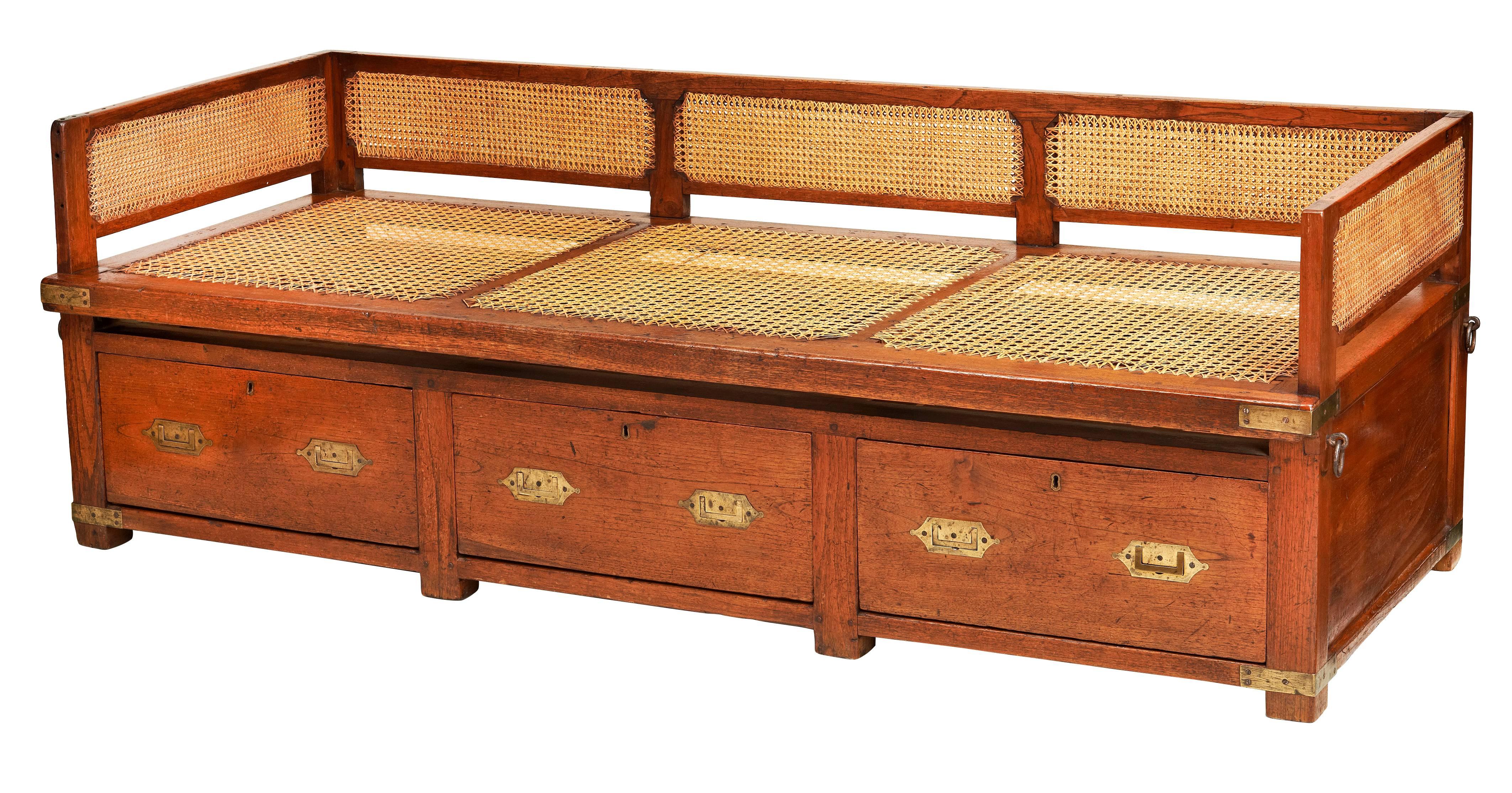 An Anglo Indian brass bound, teak Cabin Bed. This is three pieces of furniture in one giving the owner a bed, sofa and chest of drawers thus saving space in the small area that a cabin offered. It has two iron rings to each end for tying down in