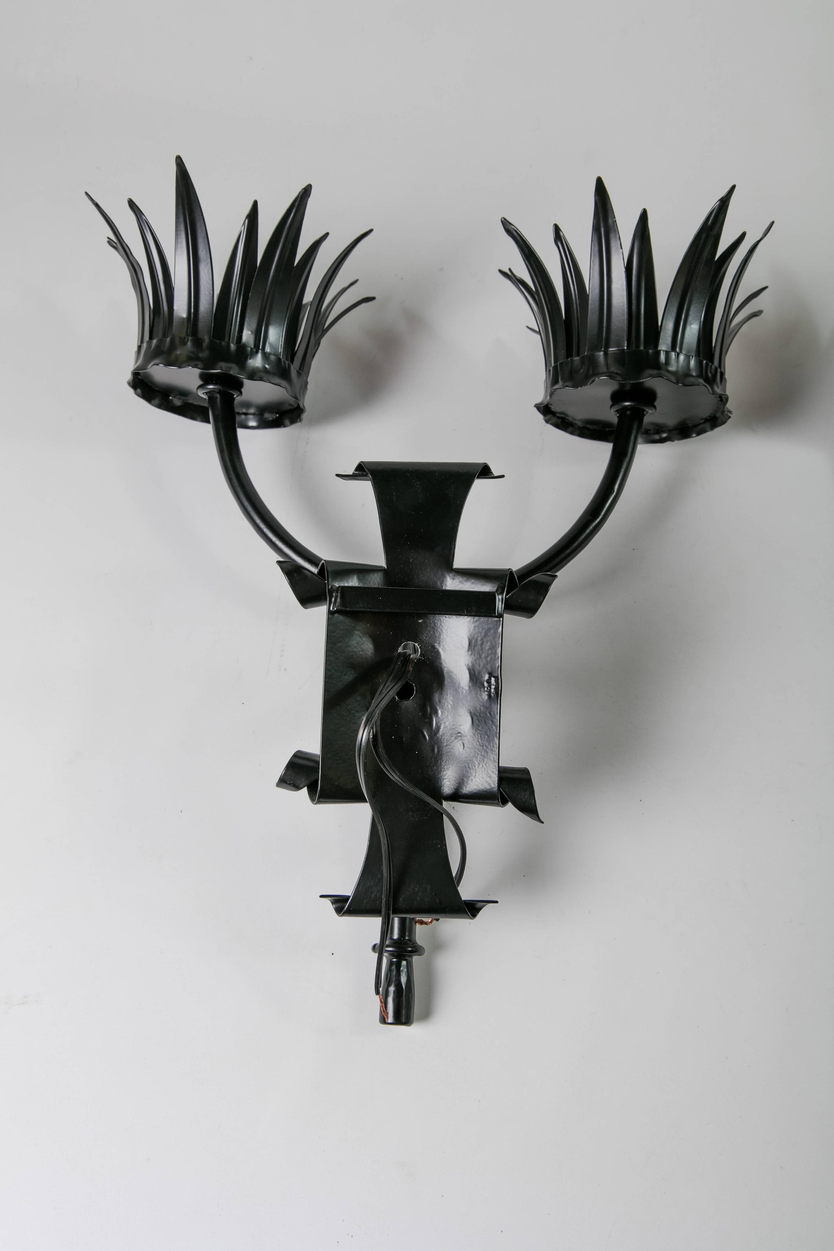 A pair of black metal newly electrified Victorian Gothic wall sconces in the style of a pair of torches. The sconces have been newly wired and powder-coated. Back plate: 9.5