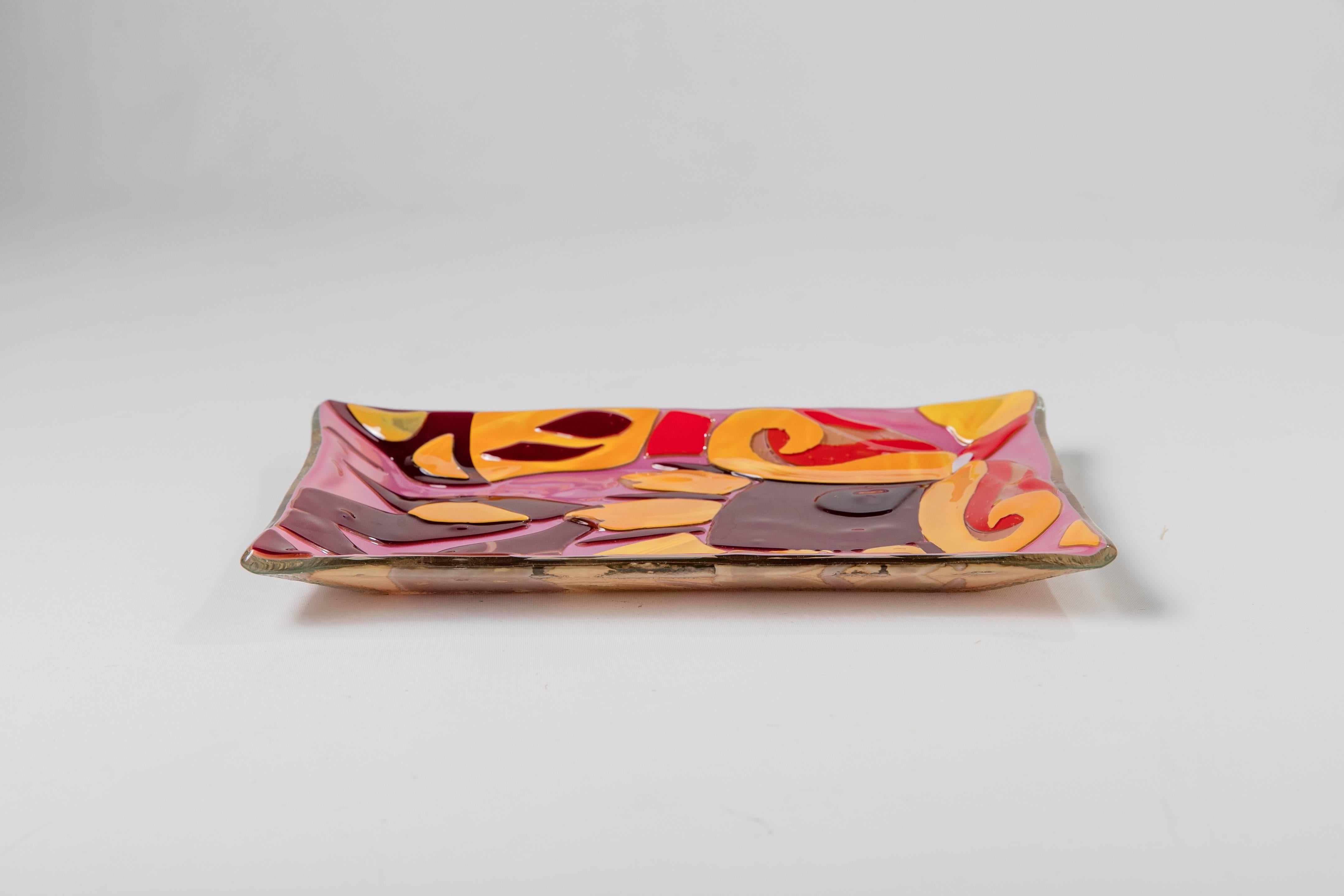 A colorful 1990s molded glass catchall from Italian luxury brand Etro with decorative pattern in yellow, red, burgundy, and mauve, perfect for holding keys and loose change.
