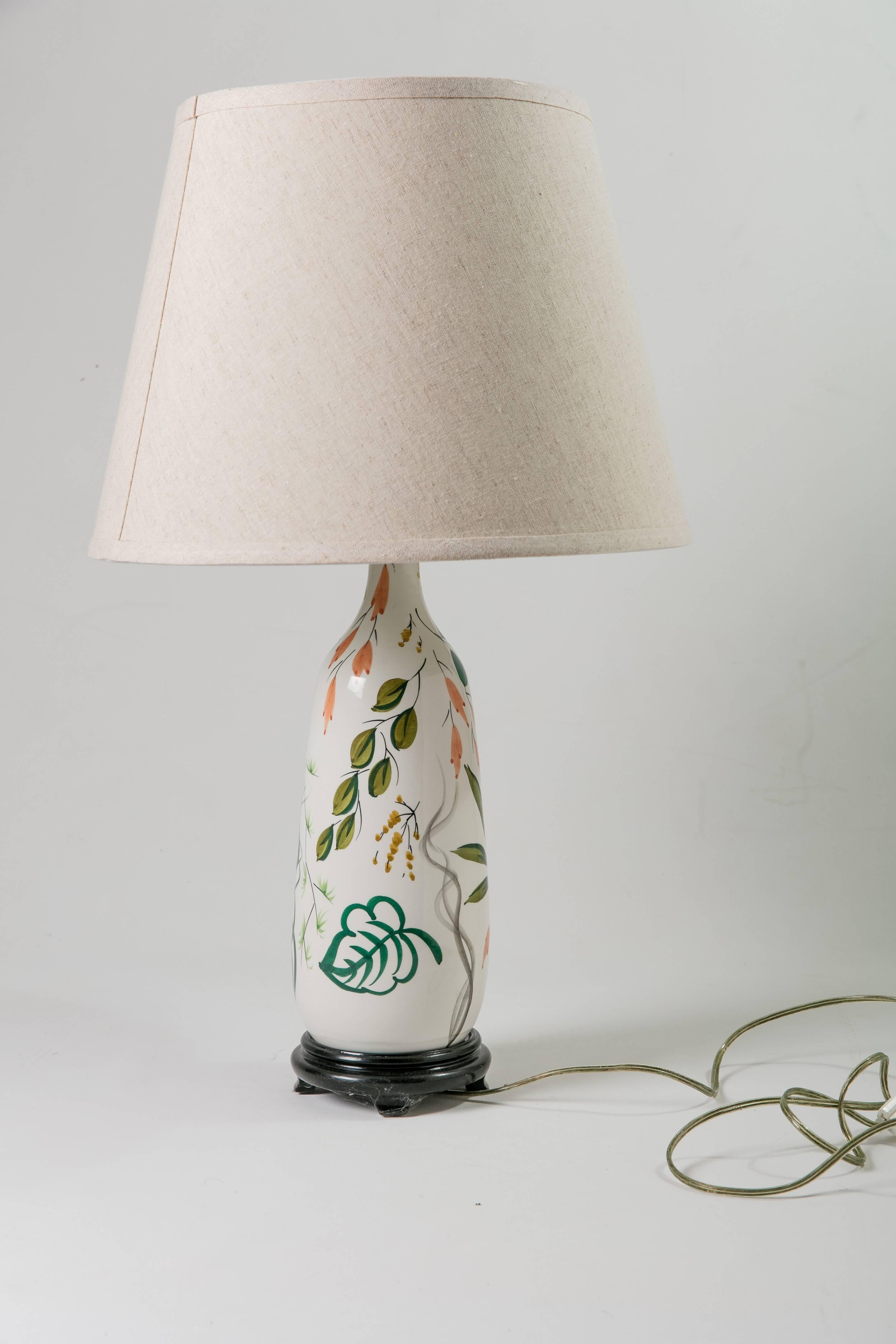 Midcentury Italian ceramic table lamp on black-painted wood base with beige linen shade. Newly wired and working; accommodates a 60W bulb. Shade, 10"Dia top x 15" Dia bottom x 11"H.