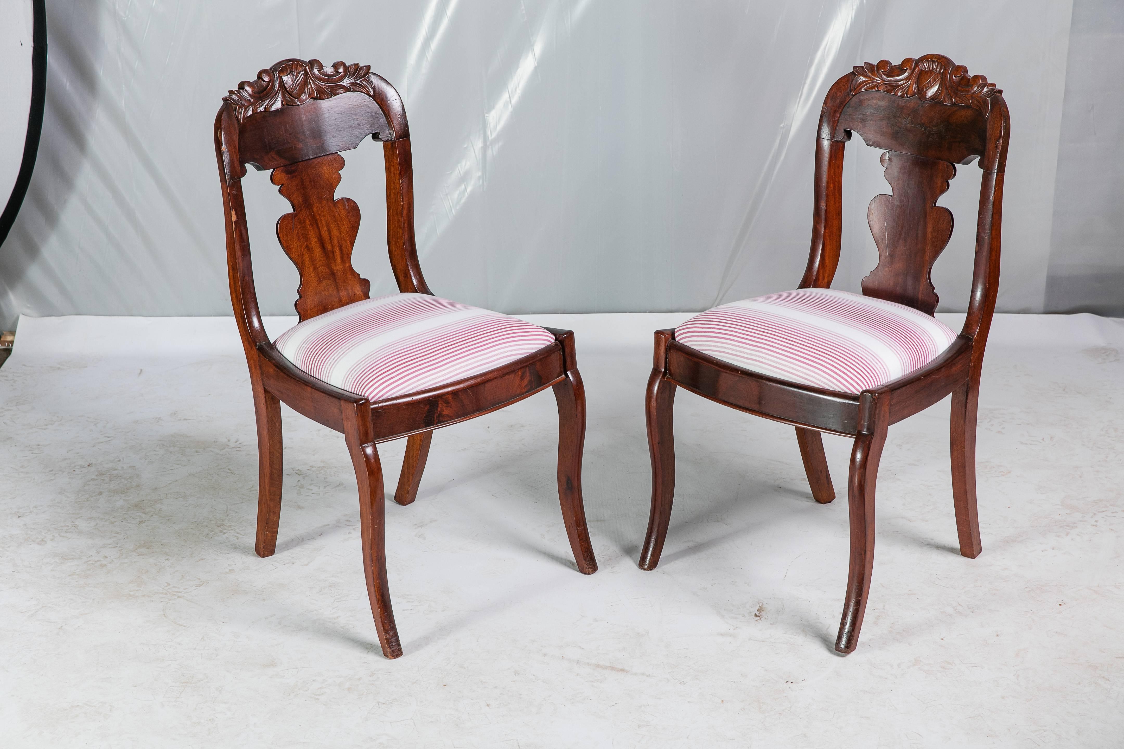 A pair of mid-19th century English shield back hall chairs covered in Madcap Cottage for Robert Allen @ Home Tivoli Stripe fabric in Rhubarb. Note how the rich wood graining and Mahogany-hued stained finish makes the red and white stripe come to