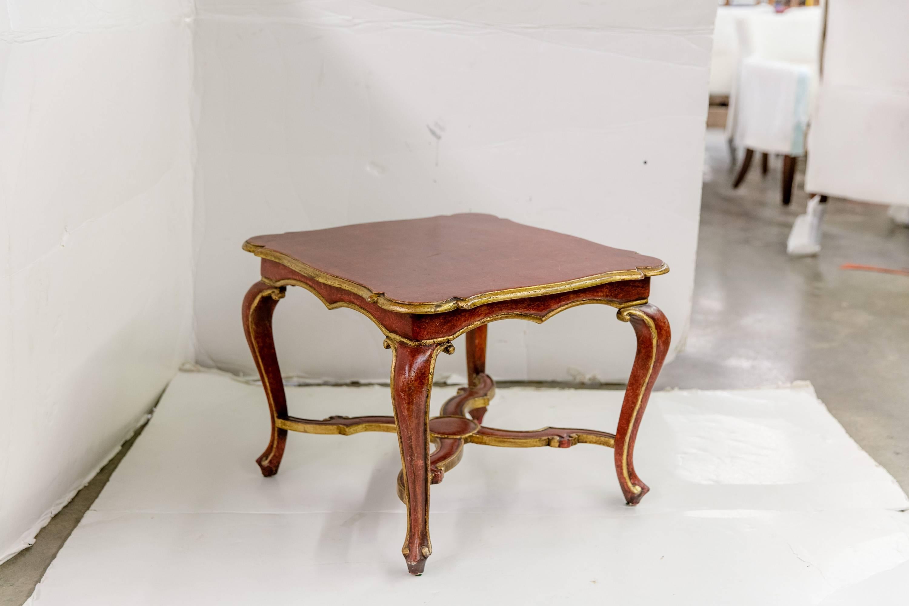 Vintage red-and-gilt Venetian side table with a distressed finish.