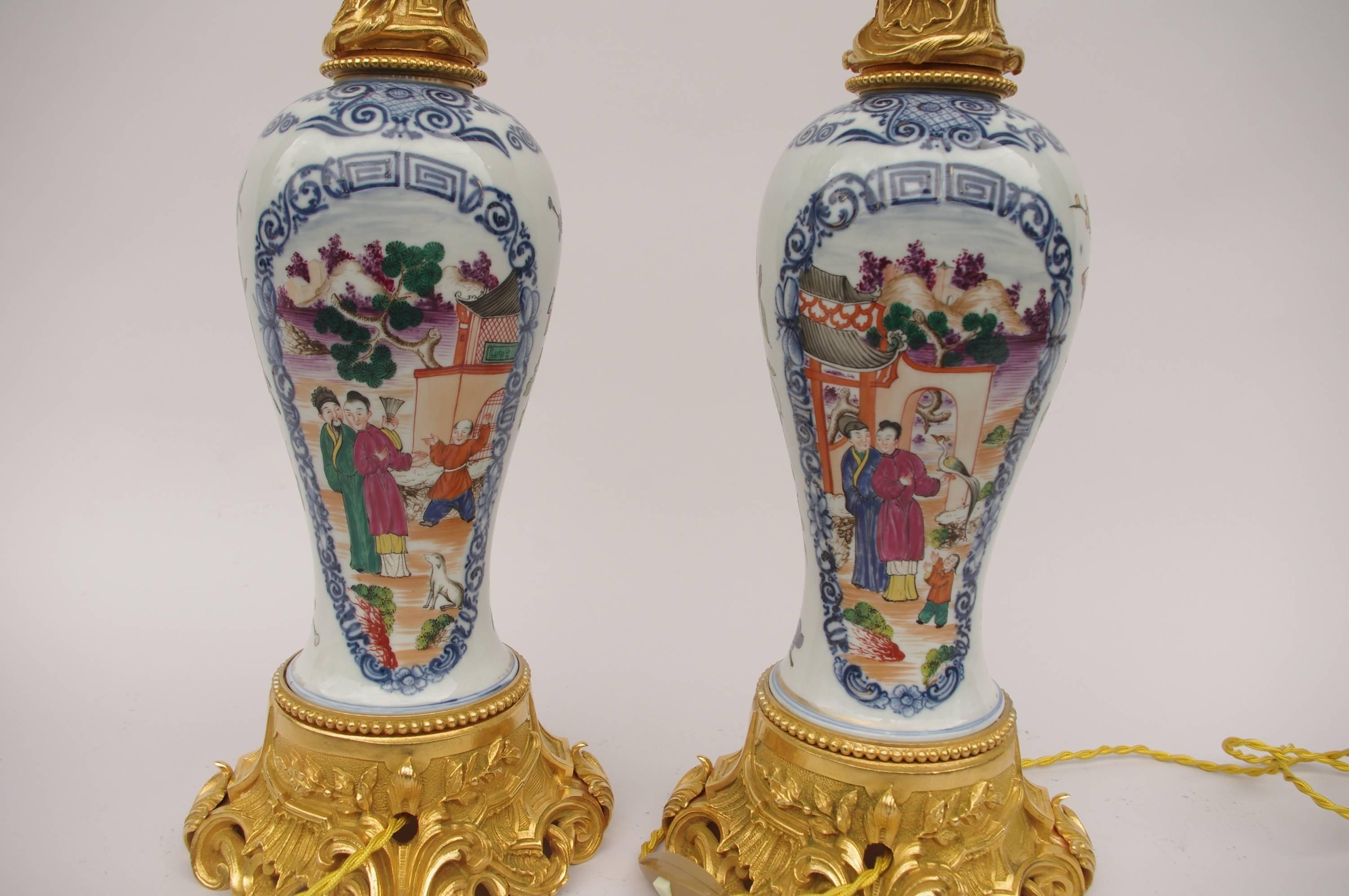 Figures decor. 
Mounted in gilt bronze, Rocaille style.
Made for electricity,
circa 1880.
Quianlong porcelain period, 18th century, from Canton.
Color of the shades can be changed, and we can make the electricity for the U.S.