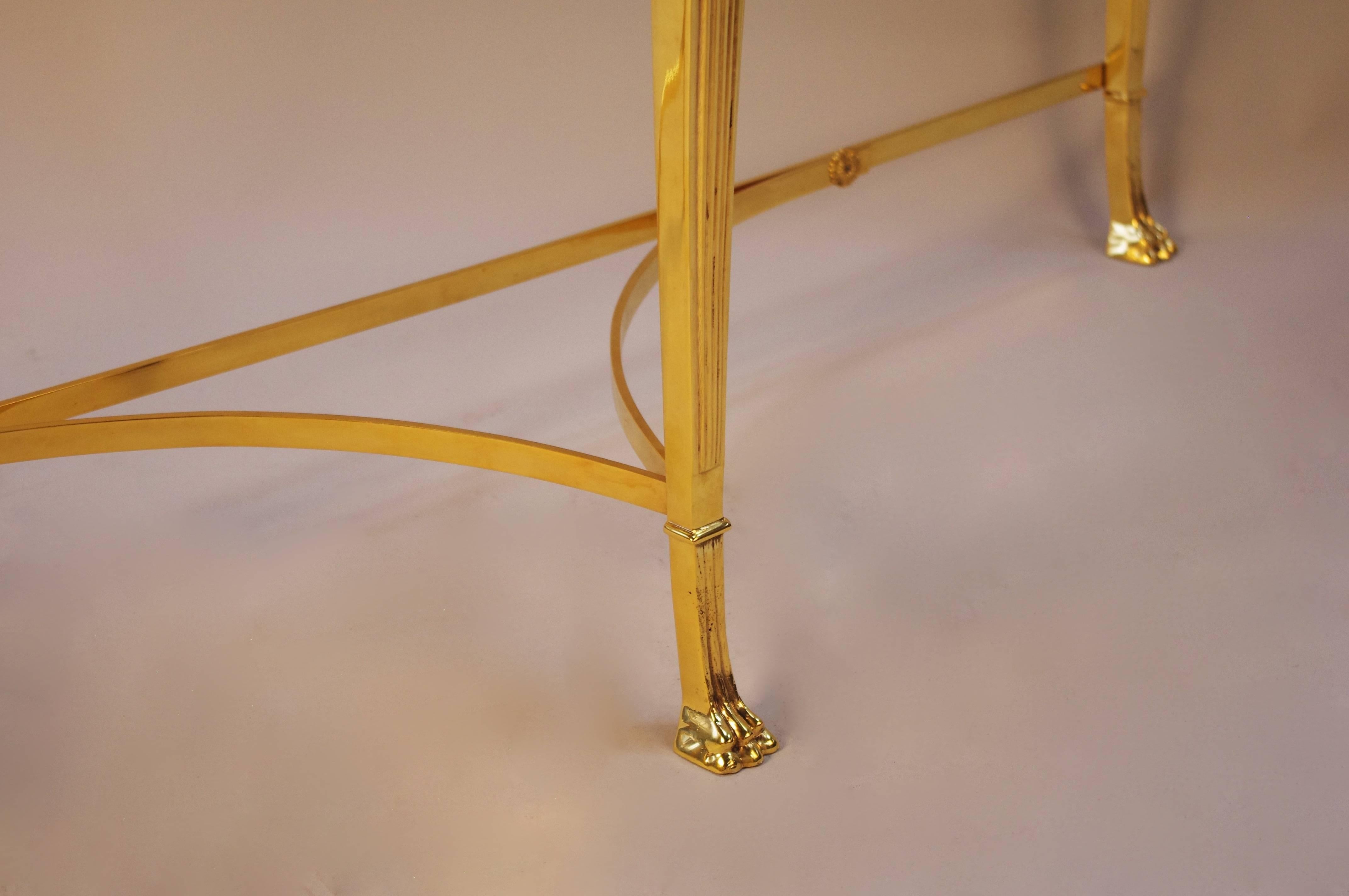 Directoire style
Gilt bronze 
Tripode base
Claw feet surmounted by a caryatid
Black marge top

  