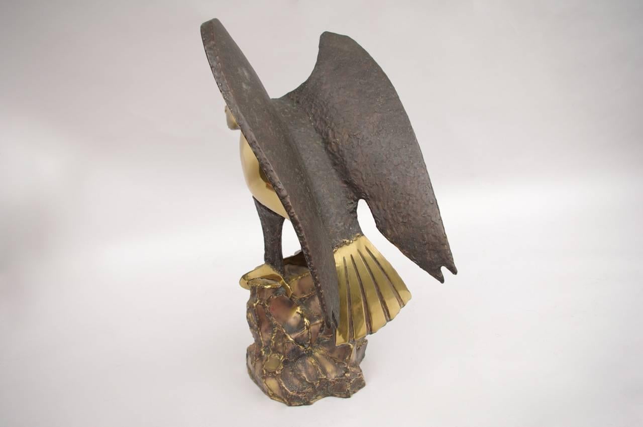 Polished soldered gilt brass sculpture figuring an eagle, which takes flight, with wings slightly opened. It stands on a gilt brass raw rock.
Signed by Daniel CHASSIN and dated 1995.

Daniel Chassin (1950-) is a French sculptor who realizes artworks