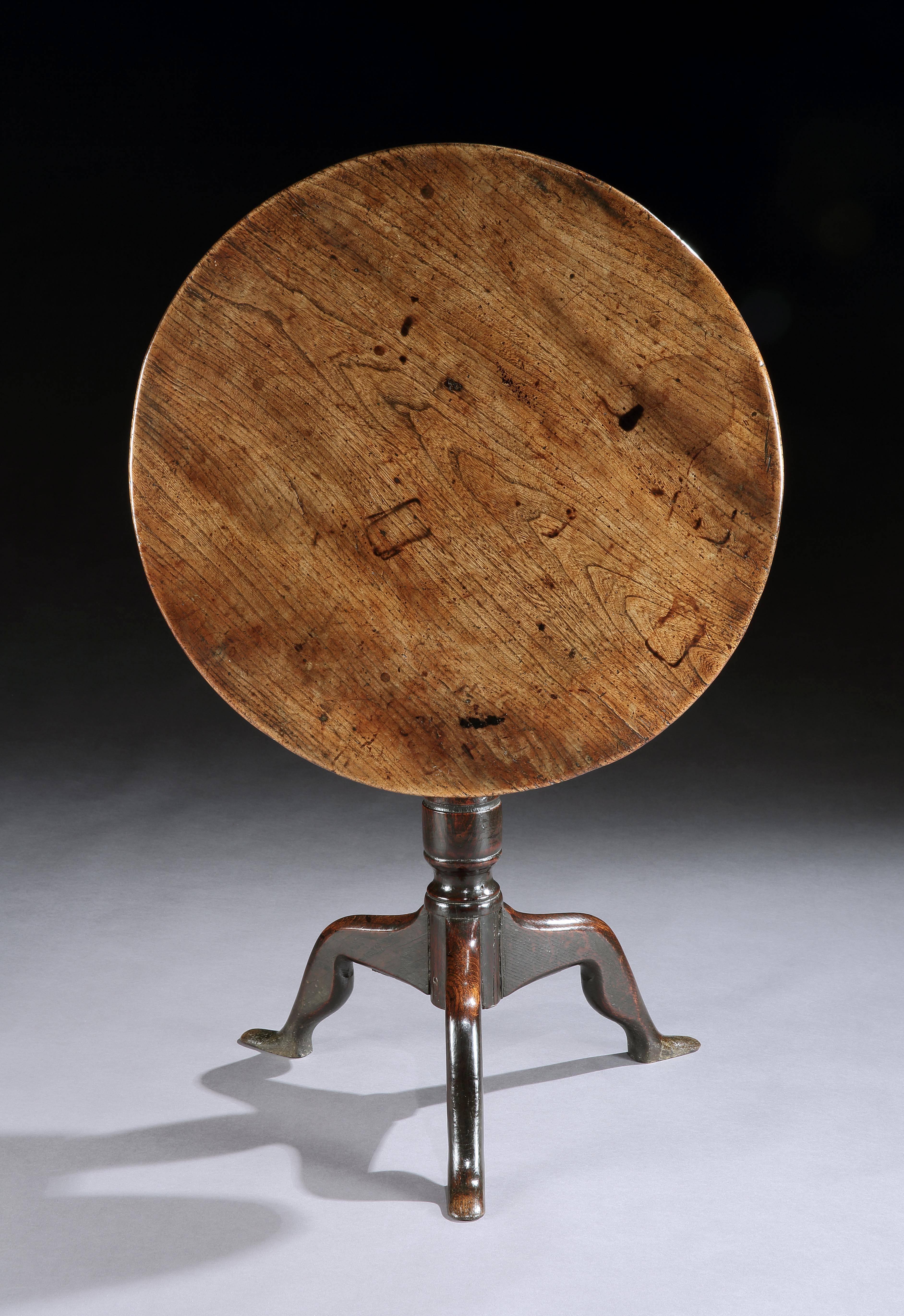 Single plank tripod wine table with revolving top raised on Silhouette “Human” leg tripod base of vernacular “Manx” form honey colored and well patinated elm and oak English, circa 1770. Measures: 25” high x 25” wide x 24” deep.
