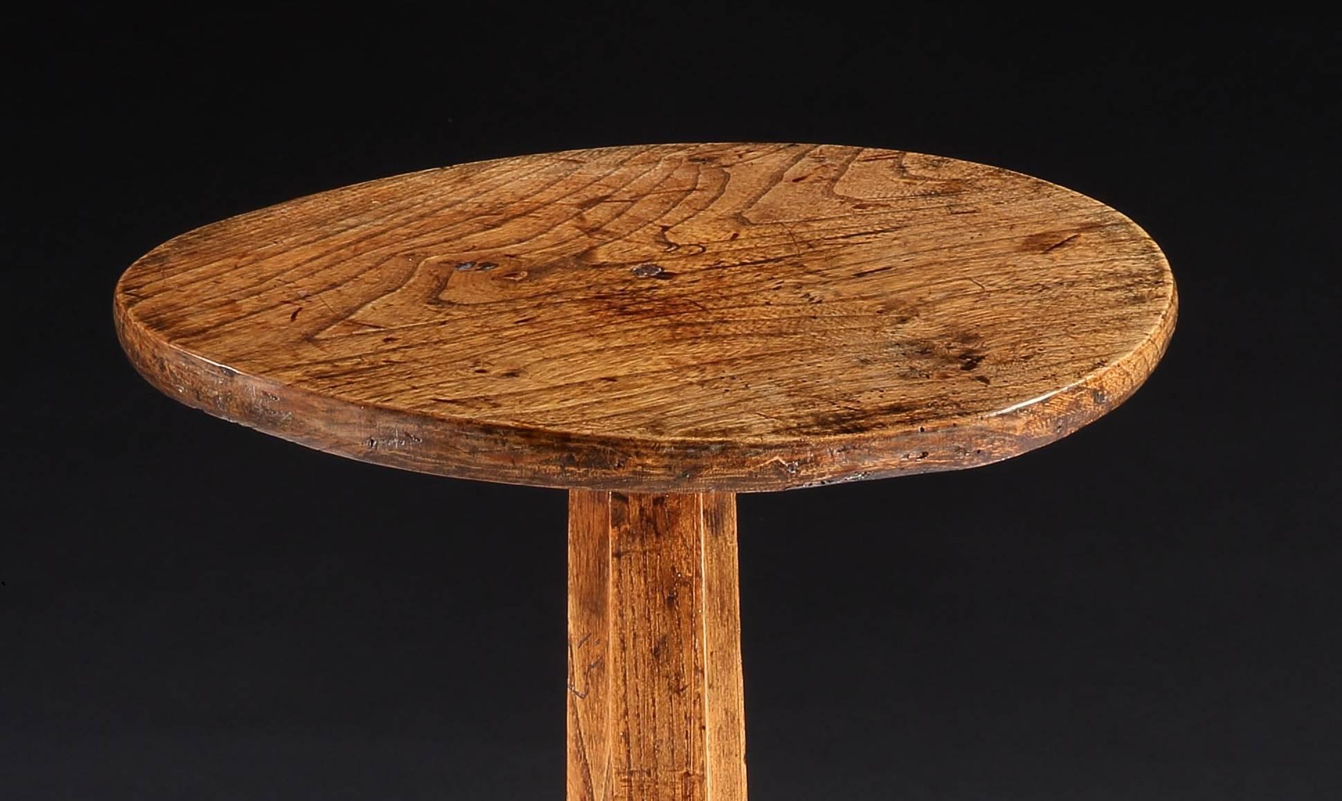 With a single piece circular top and stick legs
Solid honey colored elm
English, West Country, circa 1780
Measures: 27.25