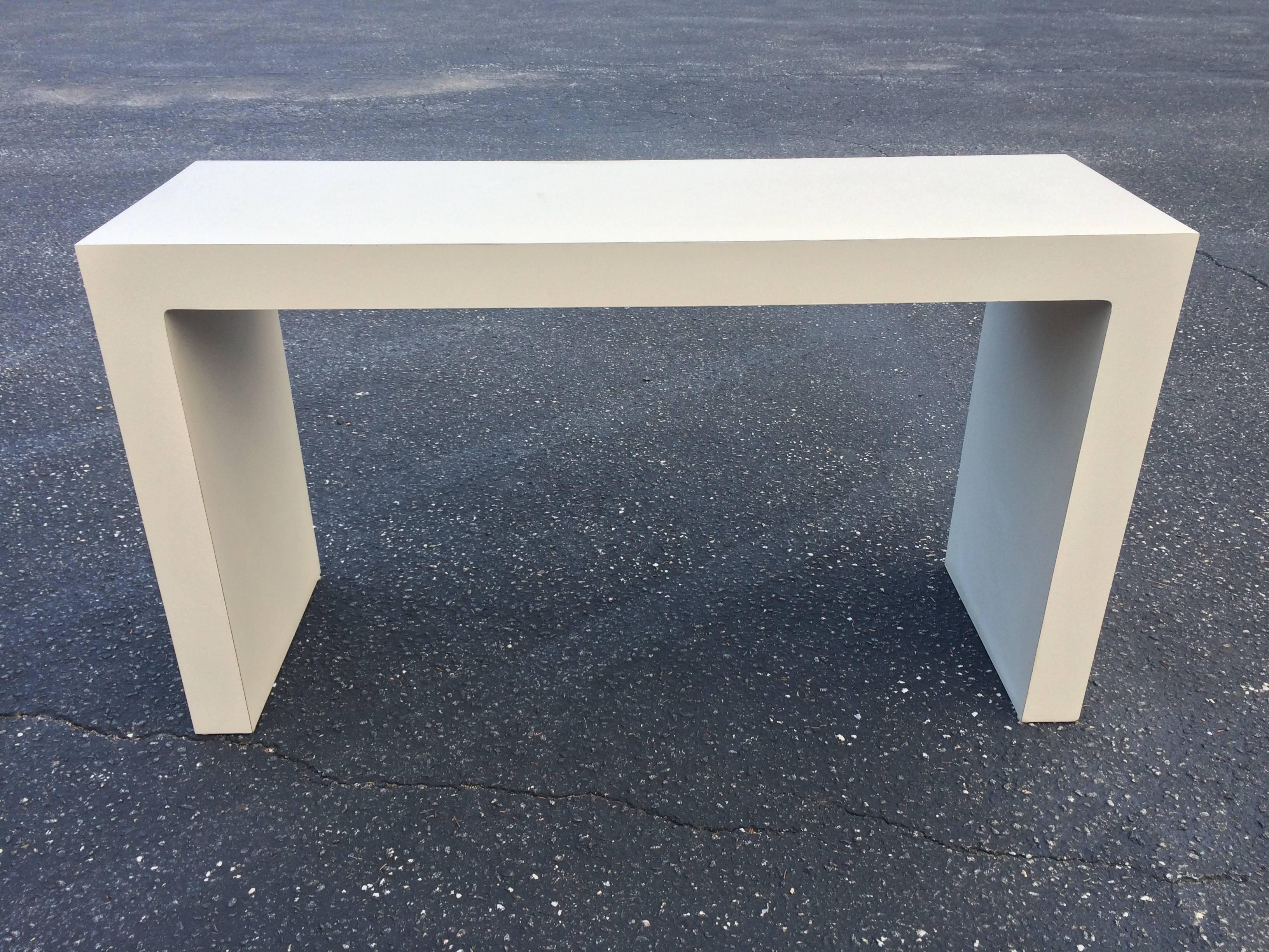 Midcentury off-white Parsons table. Perfect as a sofa table or console table. Can be used in any room wanting clean minimalist lines.Measures: 27 H x 47.57 L x 15.57 D.