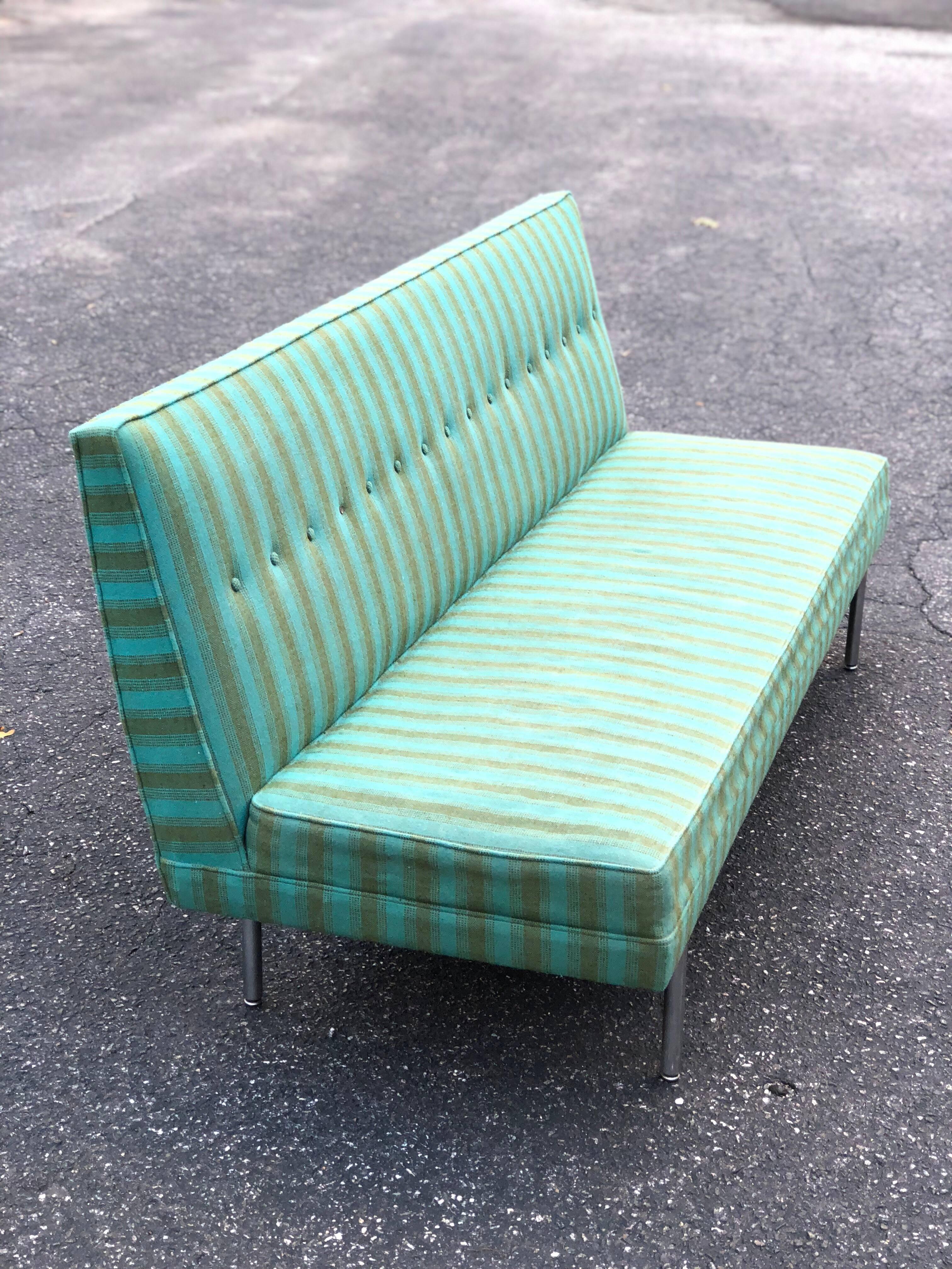 Mid-Century Modern Sofa. Great lines make up this sleek,timeless piece. This tailored,minimalist sofa is armless and is covered in its original pinstripe fabric.  We suggest a total recover as the foam has some dry rot, missing one button. Original