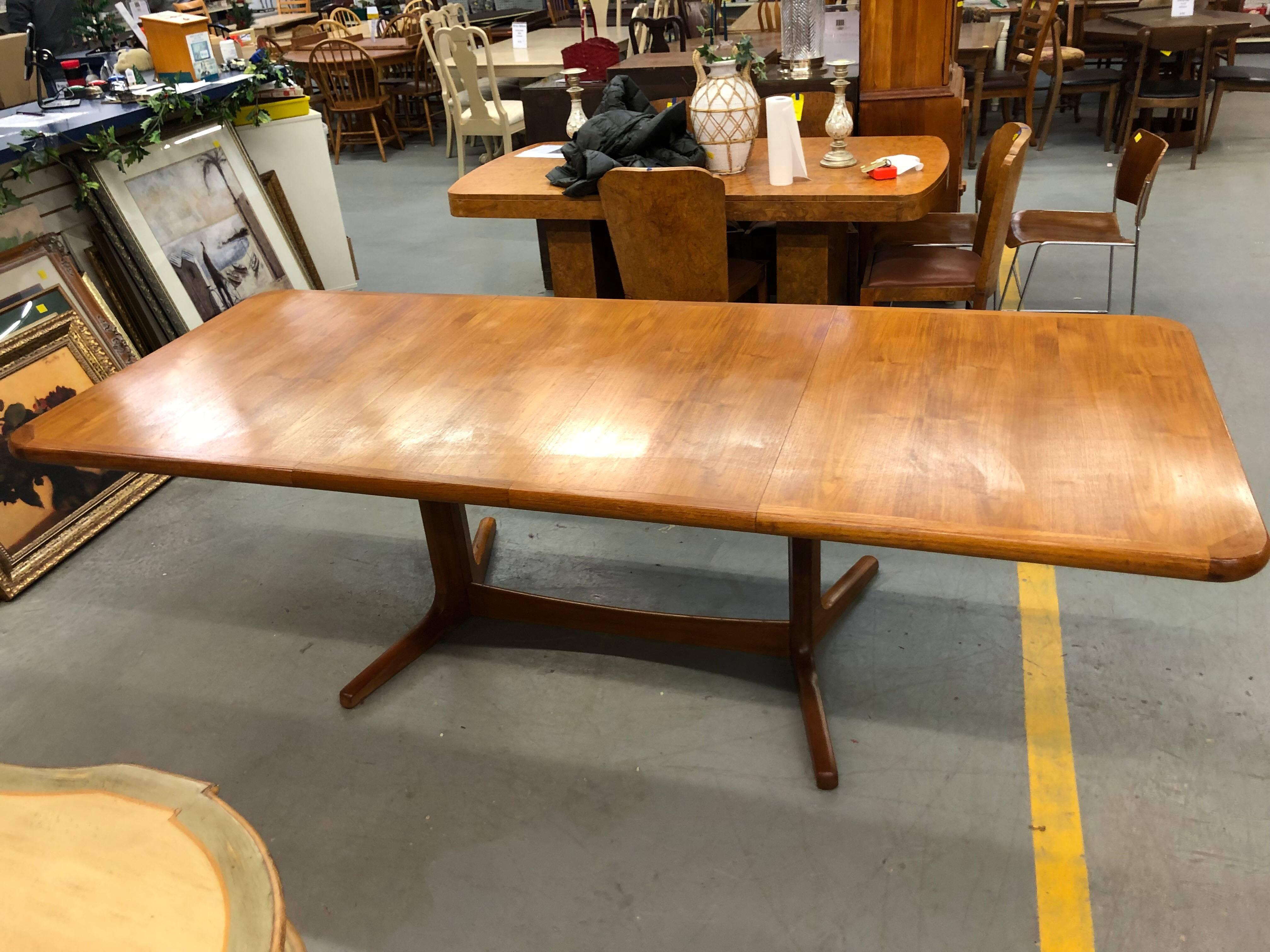 Mid-Century Modern solid teak extension dining table. Fabulous for large parties with two leaves which are stored inside the table.