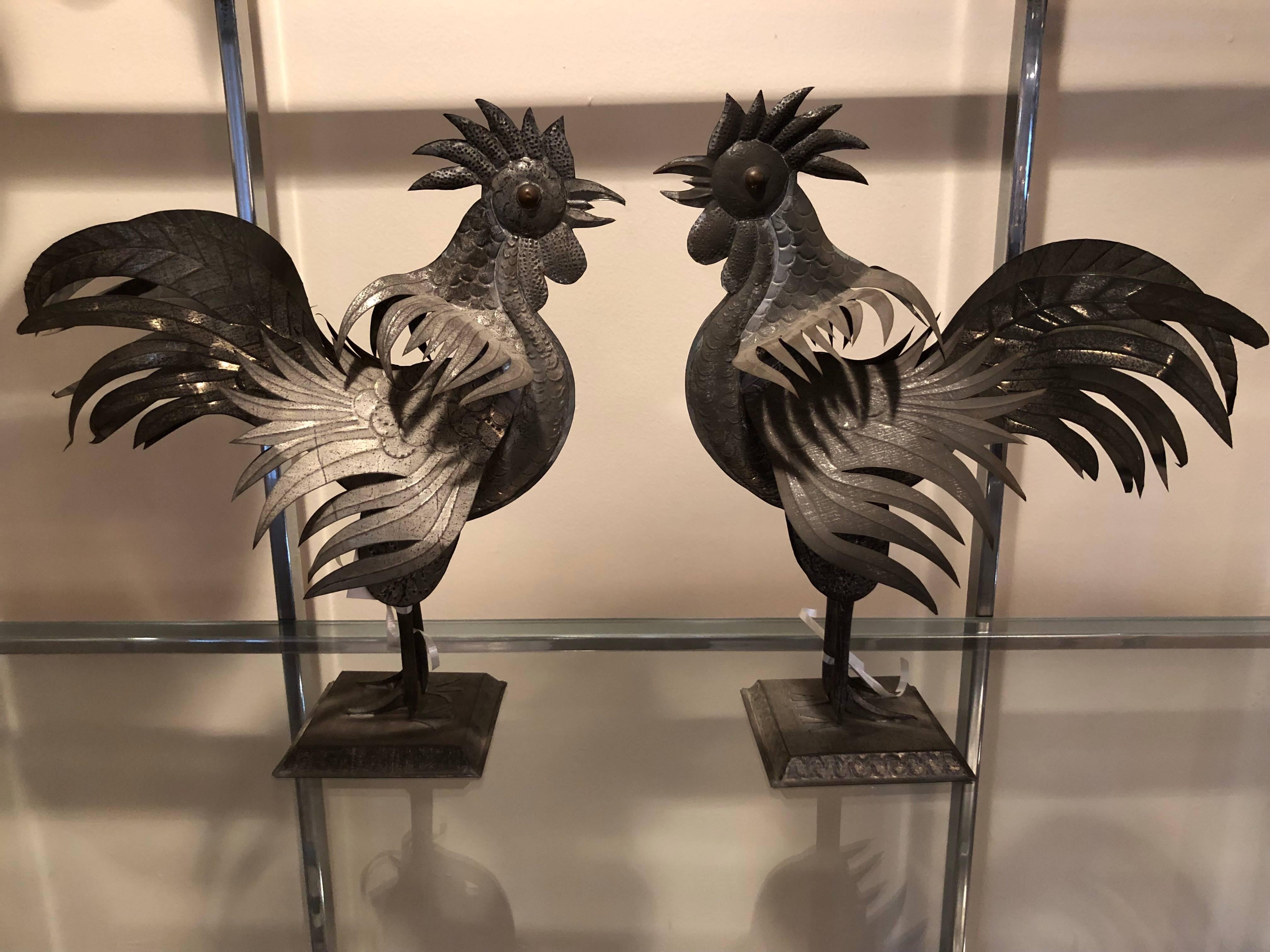 Pair of antique Mexican Folk Art Tin Roosters with weighted base and copper eyes.
