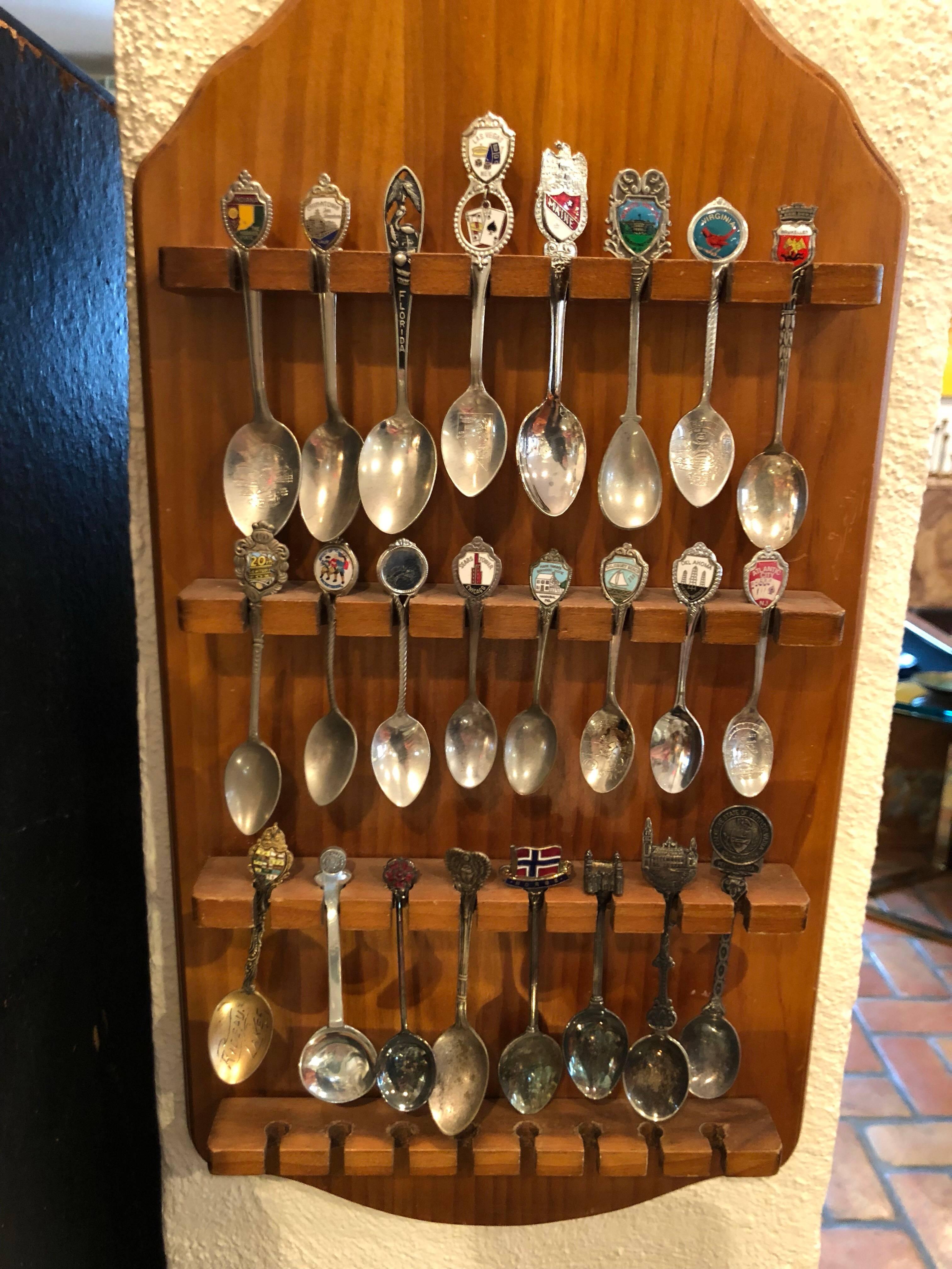 Vintage Tourist Spoon Collection. Collected over many years of traveling . Many sterling and enamel. 24 spoons in total on a nice wooden display board. Perfect gift for a collector.