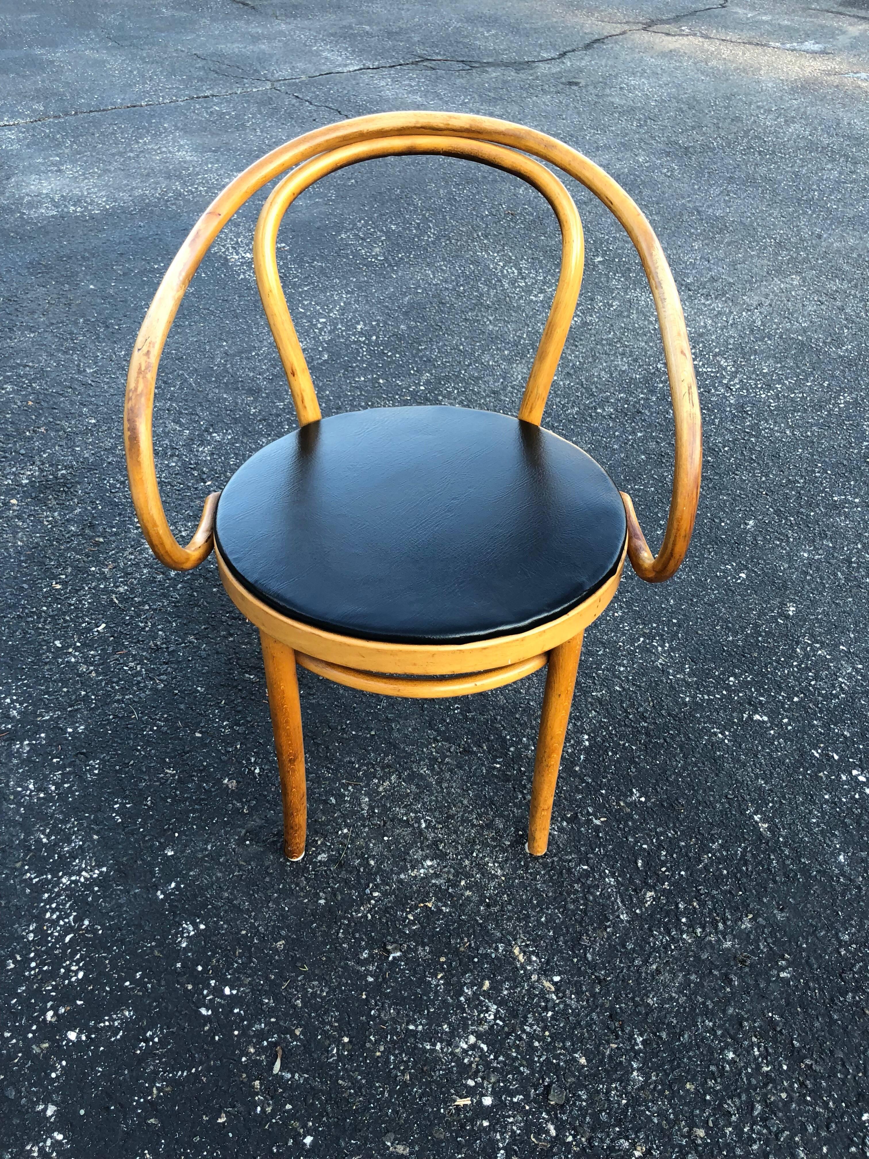 Vintage Thonet bentwood armchair with black vinyl seat cover.