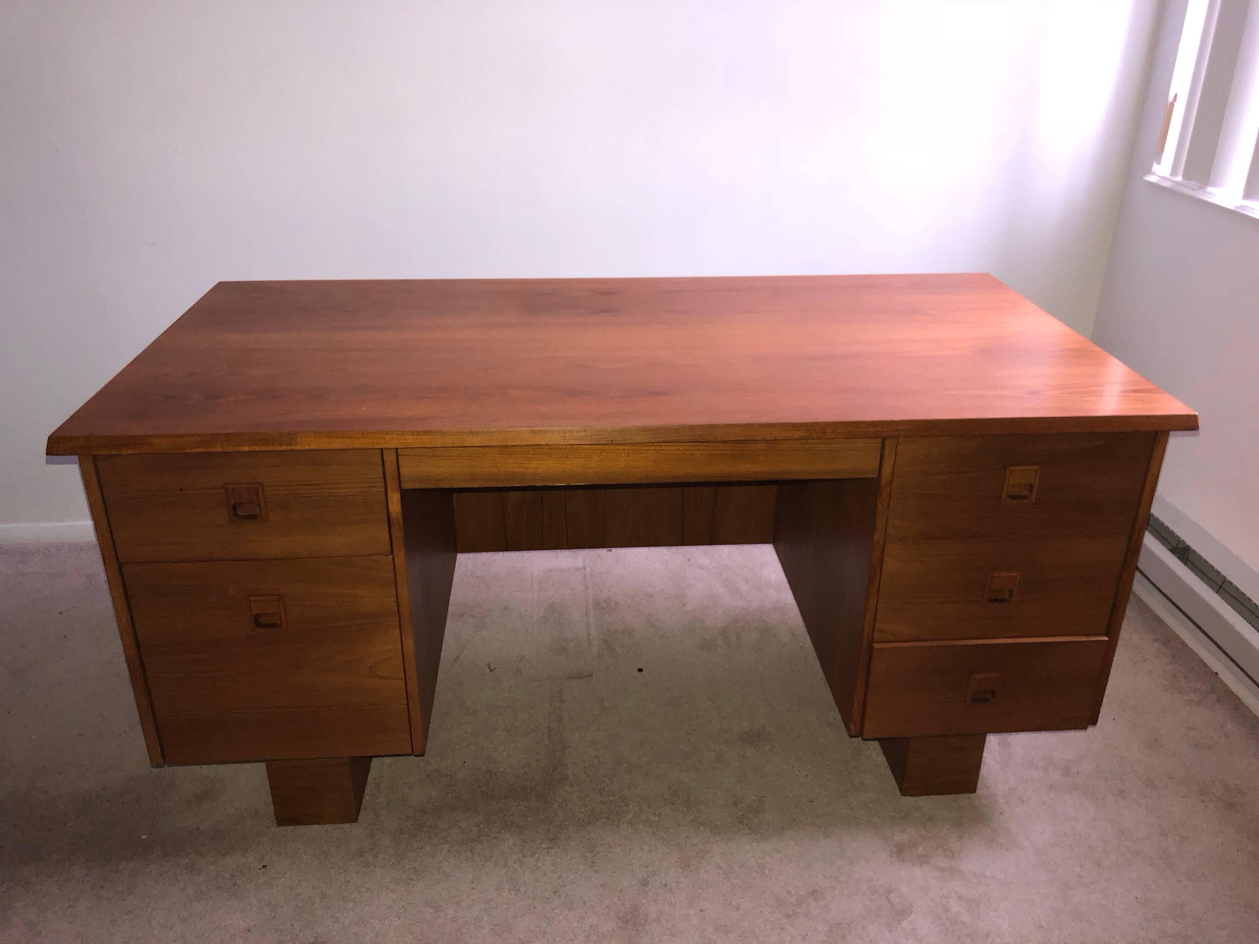 Mid Century Modern Teak Desk. Tons of desk top space and storage. File cabinet lower left side. Stamped made in Canada. Veneer over pressed wood.