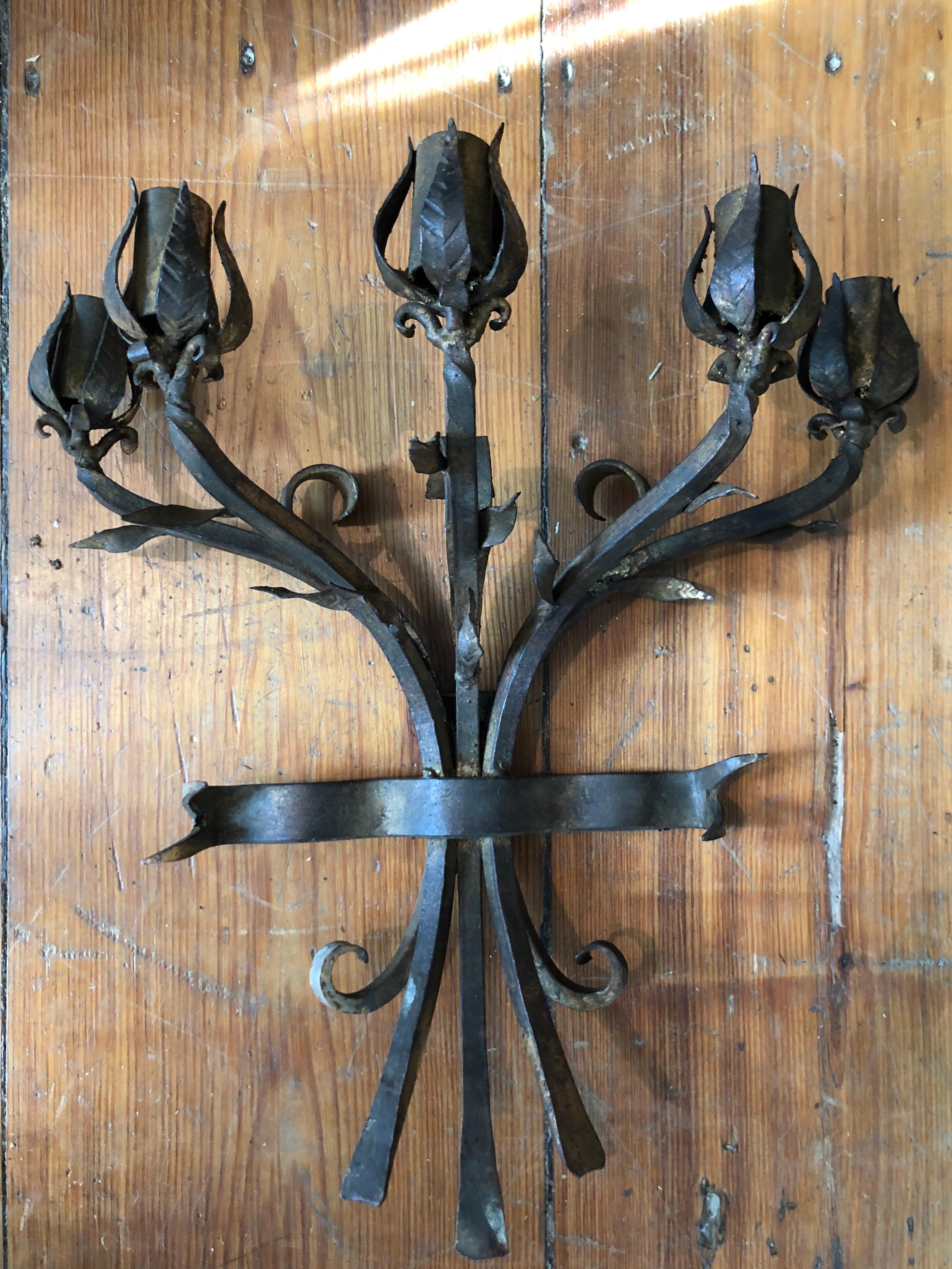 Heavy hand wrought iron wall candelabra. Intricate detailed craftsmanship of five roses in a bouquet shape. One of a kind artisan piece. Heavy and substantial. Holds 5 candles. This item can parcel ship domestically for $49
   