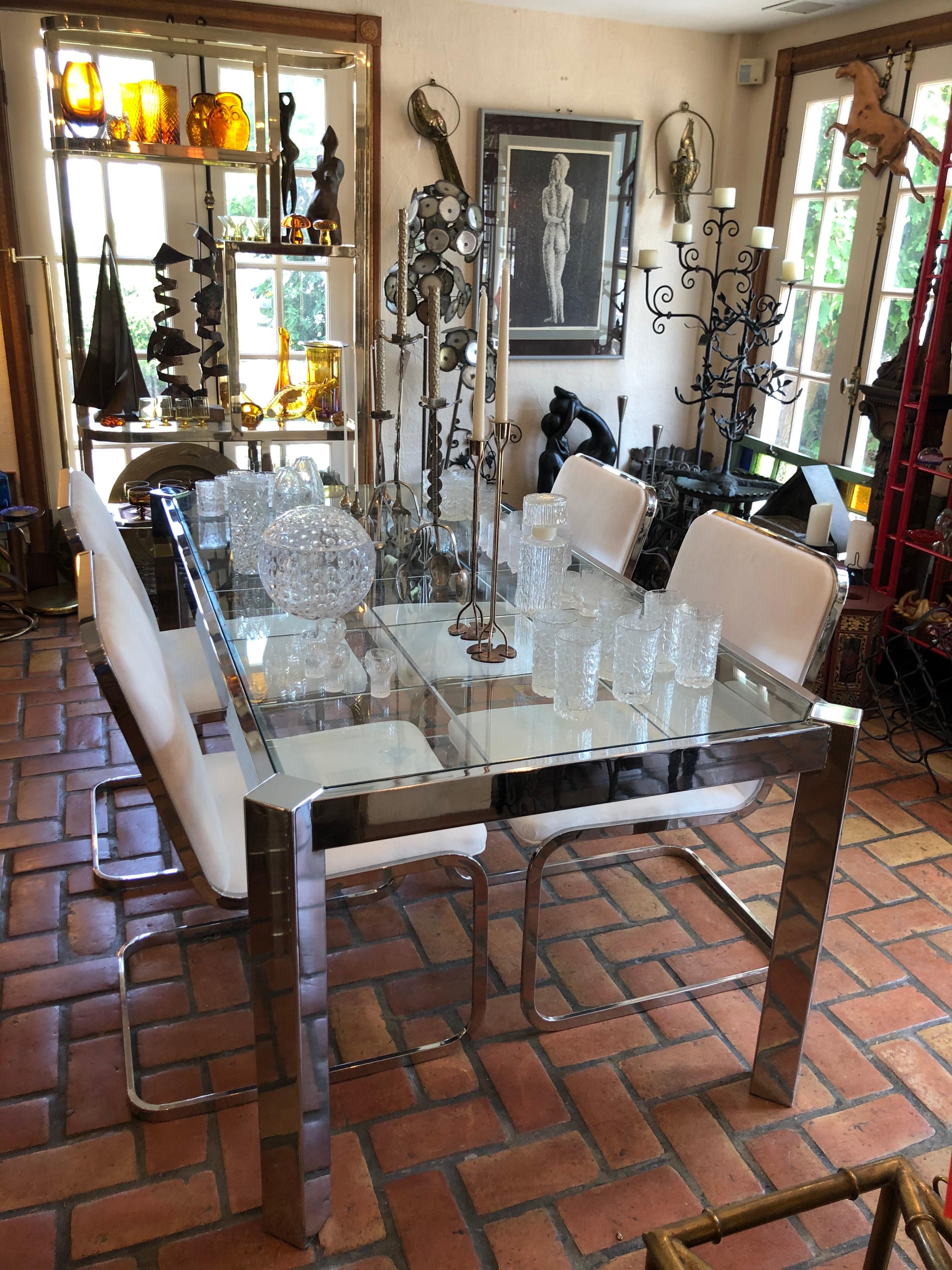 Design Institute of America (DIA) chrome and glass dining table. Mint condition. The epitome of high end chic. Sleek Parsons lines make up this table with its faceted, incised and grid patterned glass top. Canted legs make this an unusual design