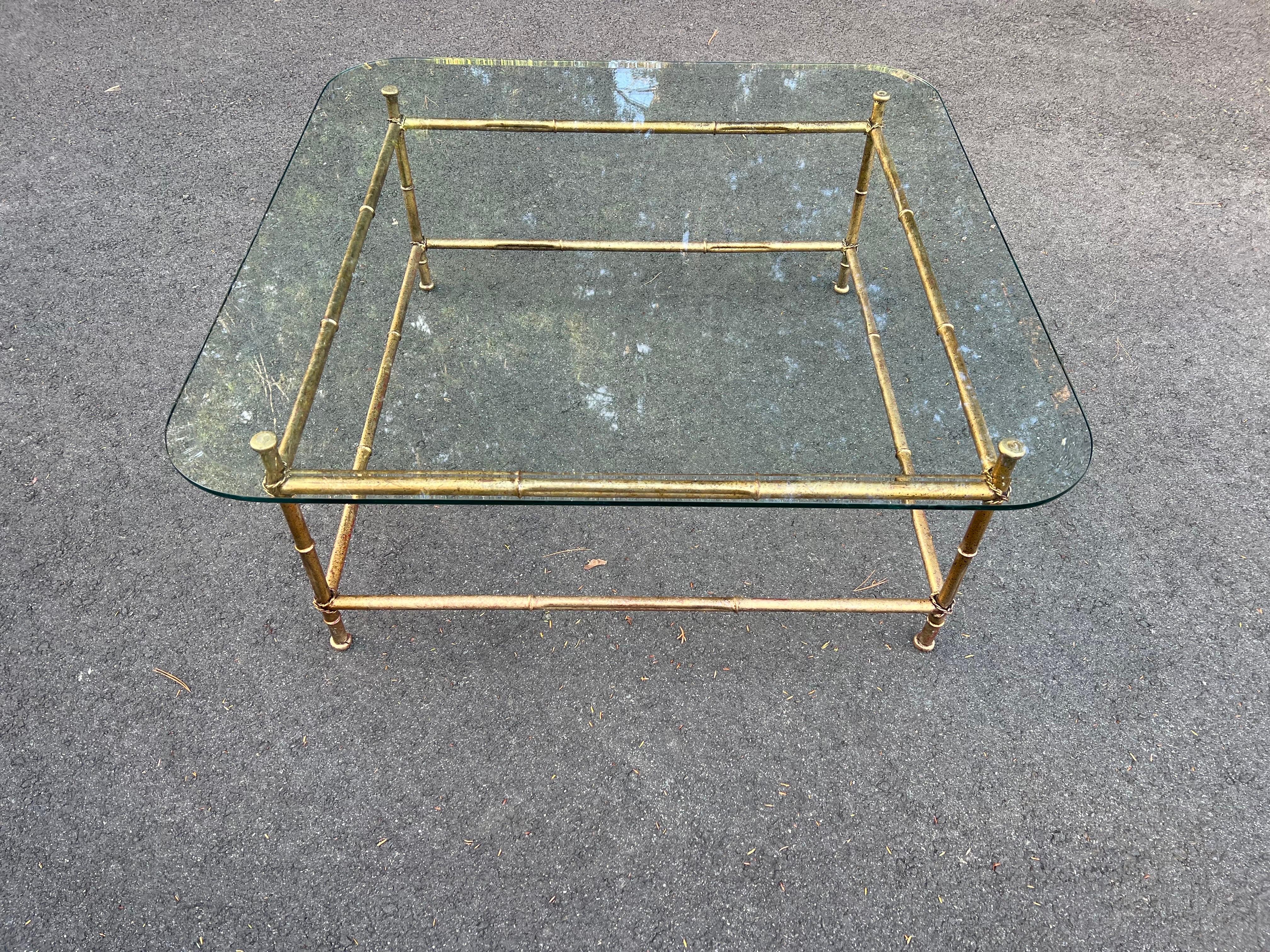 Faux bamboo glass and gilt metal coffee table. Elegant and sleek designer coffee table . Square glass top with rounded corners and a nice thick bevel. Perfect for that designer living room.