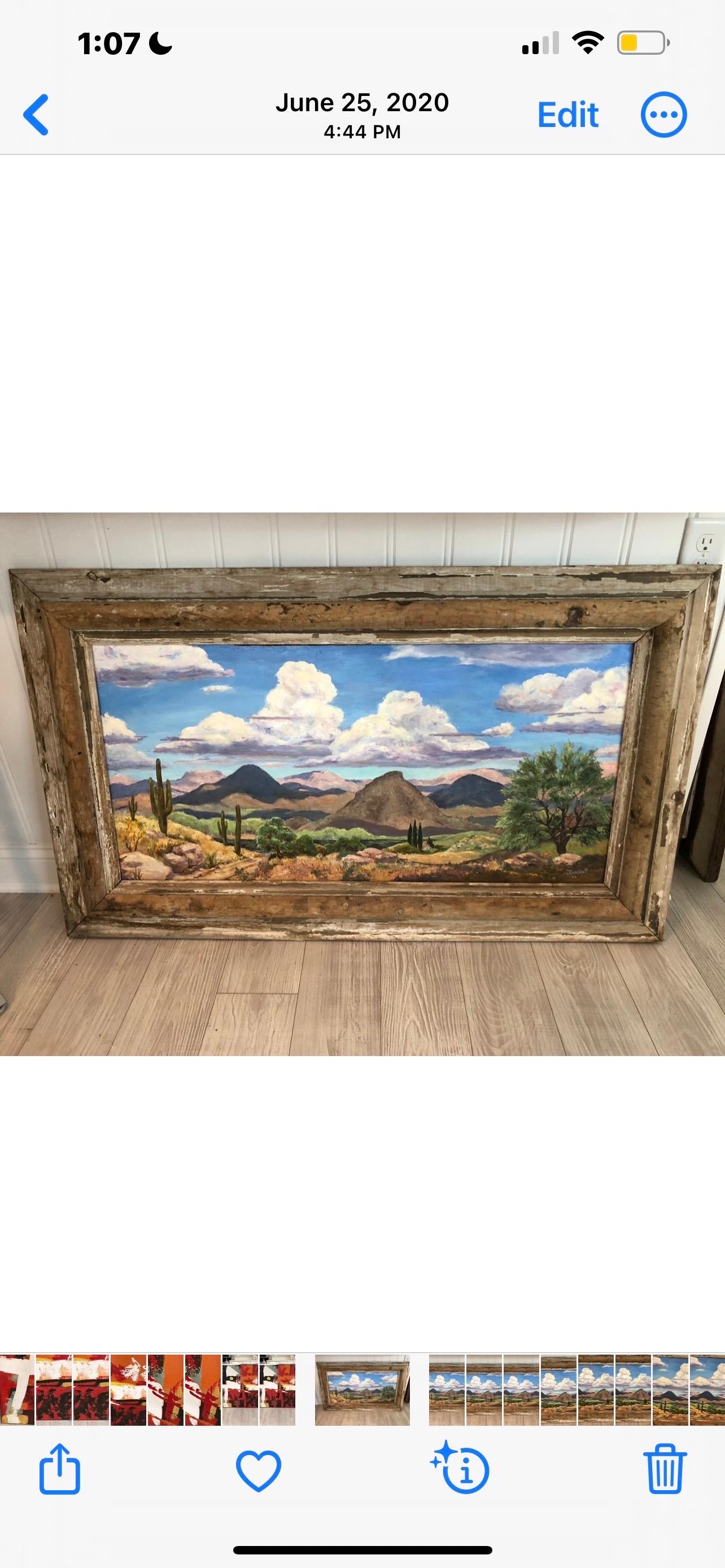 Large Signed Southwestern Desert Landscape Painting on board. Signed Jeanine 2003. Vast expansive view of the desert , its rolling clouds and its mountains in the background. Distressed  wooden antique frame.
