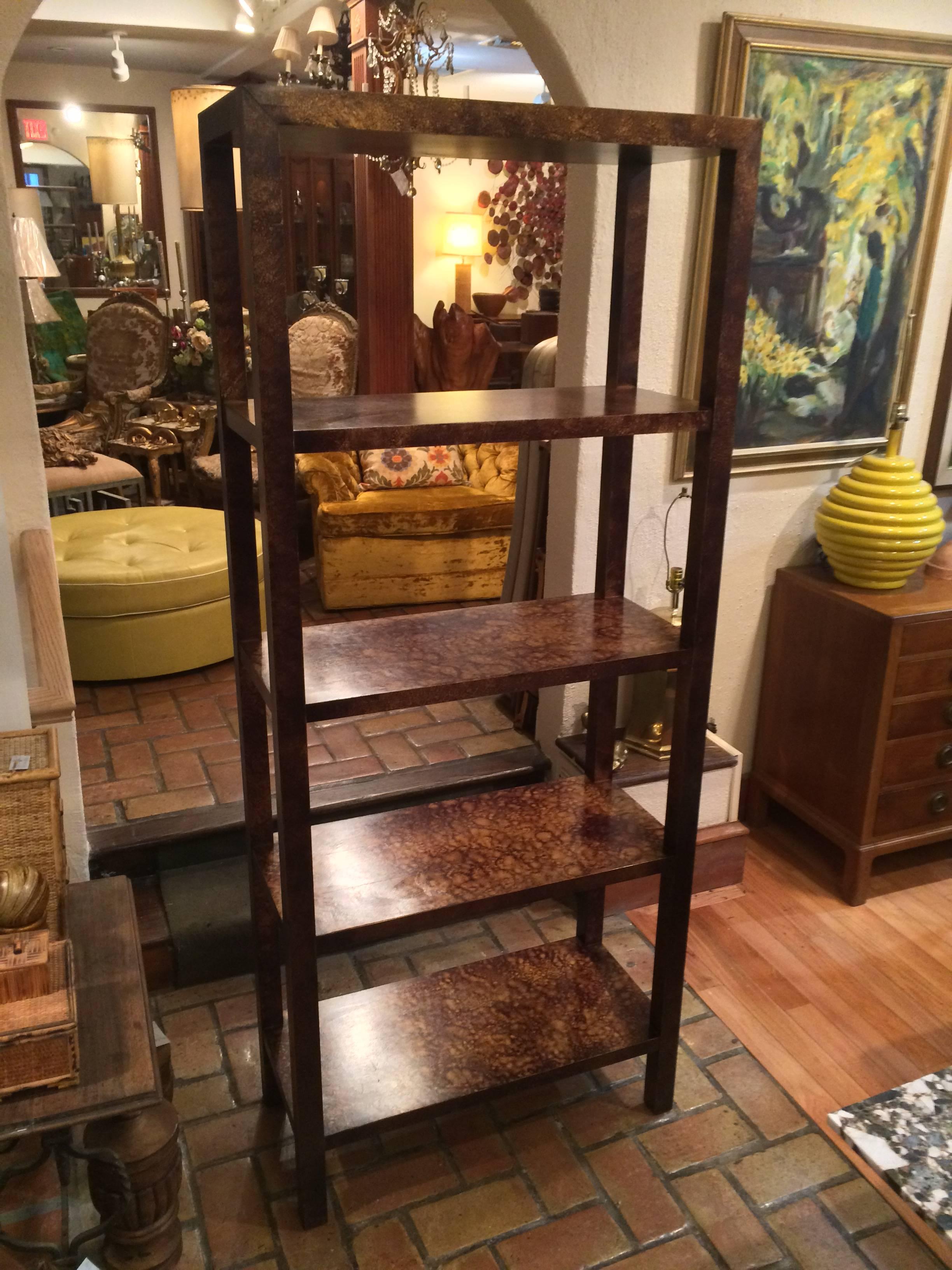 Wooden hand-painted faux tortoise shell Etagere by Lane. Simple lines make up this parsons style etagere. It has fantastic storage and or display with four equally spaced shelves. Use as a room divider as it is finished on both sides.The space