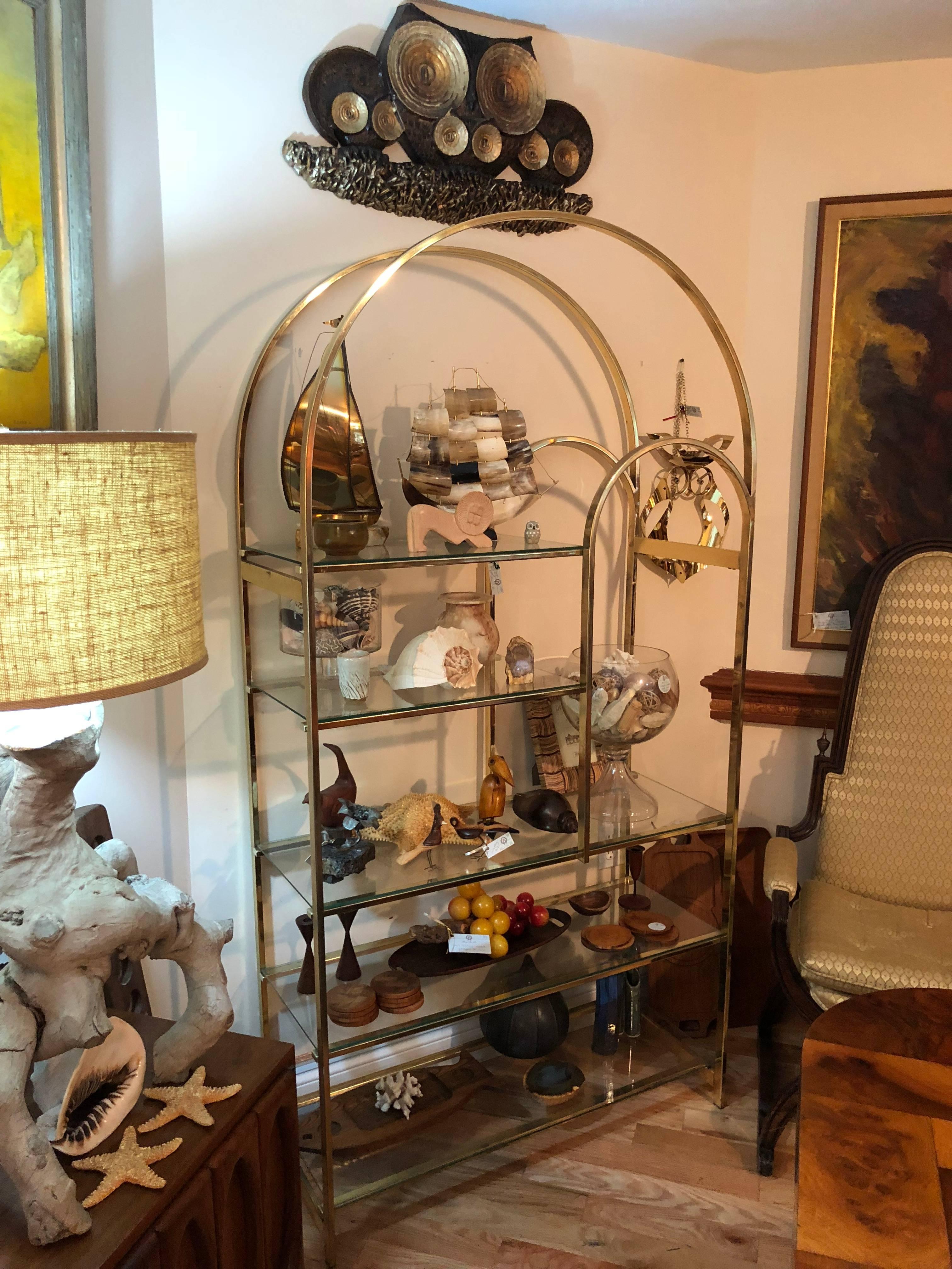 Hollywood Regency brass etagere with five glass shelves. Most likely by Milo Baughman.