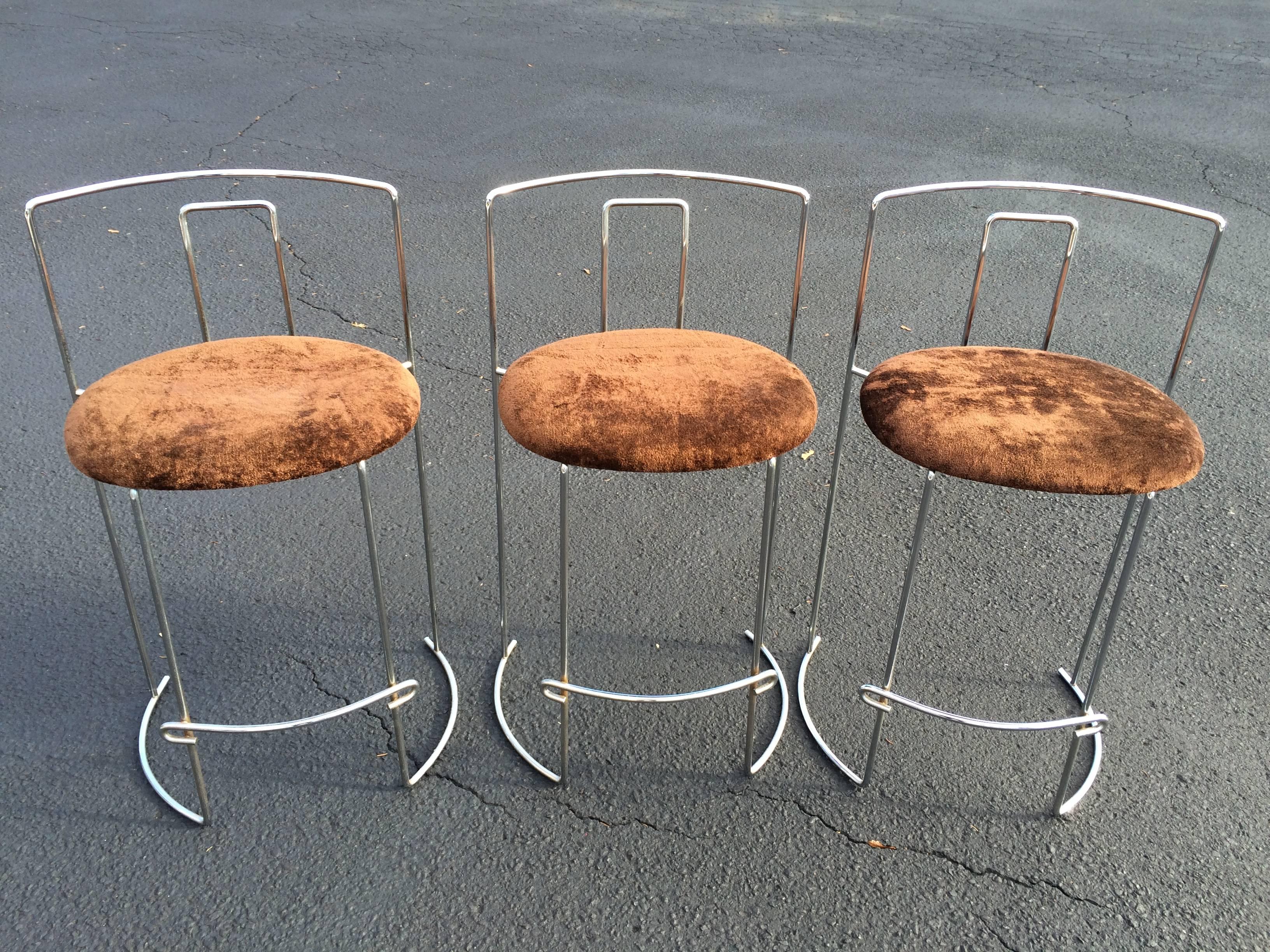 Set of three chrome bar stools by Kazuhide Takahama. Manufactured by Simon in Italy. These welded chrome-plated steel frames are light, stackable and downright sexy. Excellent condition. The upholstery is a durable chocolate brown crushed velvet.
 