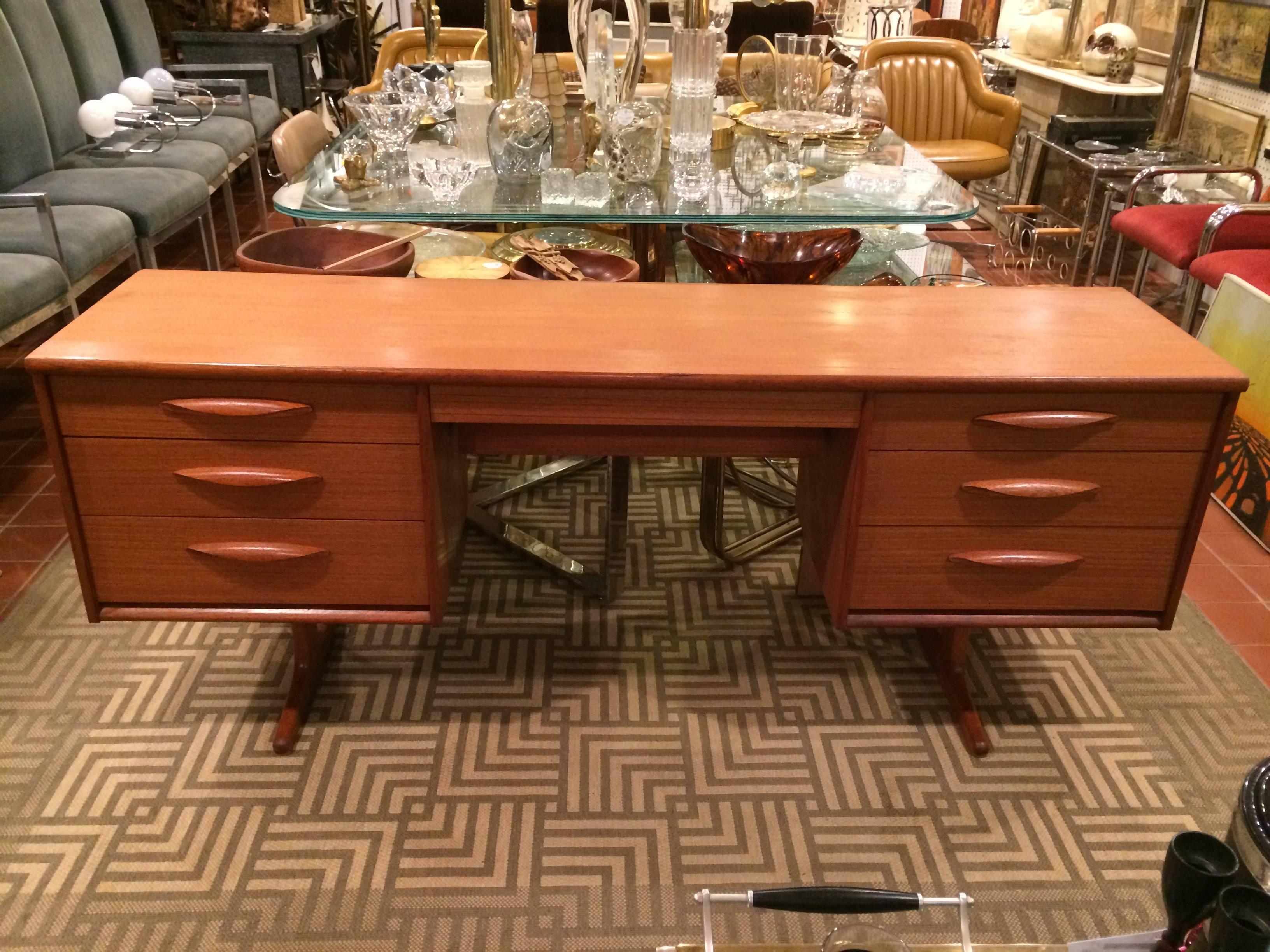 Danish Mid-Century Modern Floating teak desk or vanity. Made up of seven drawers. The center drawer is exceptionally deep with a recessed lower tier.Great for office or dressing room.