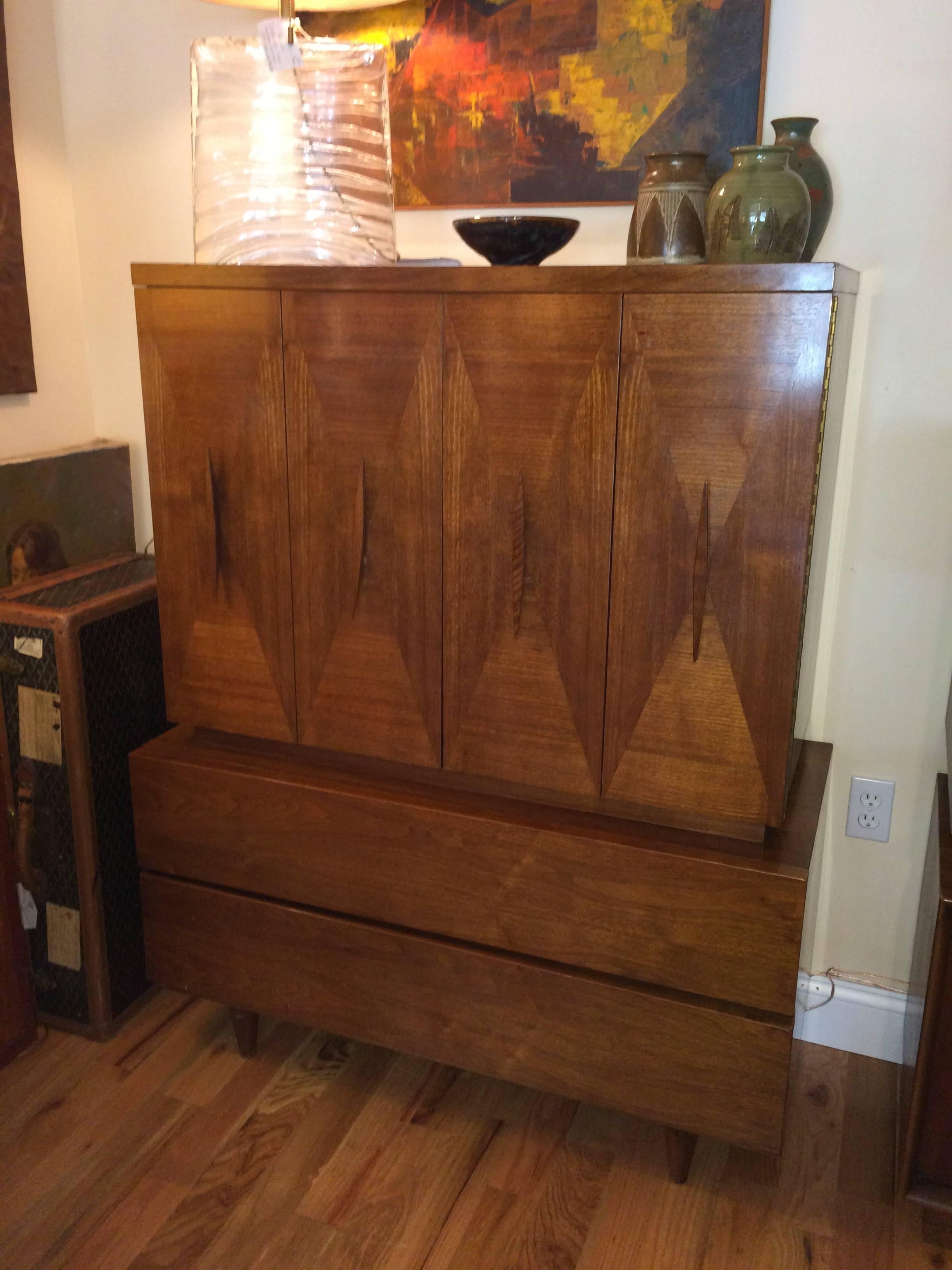 High quality Mid Century Modern Highboy attributed to American of Martinsville. Fabulous diamond shape Inlaid parquetry doors and sleek hardware make up this fine piece. Double doors open to three interior drawers. The first bottom drawer below the