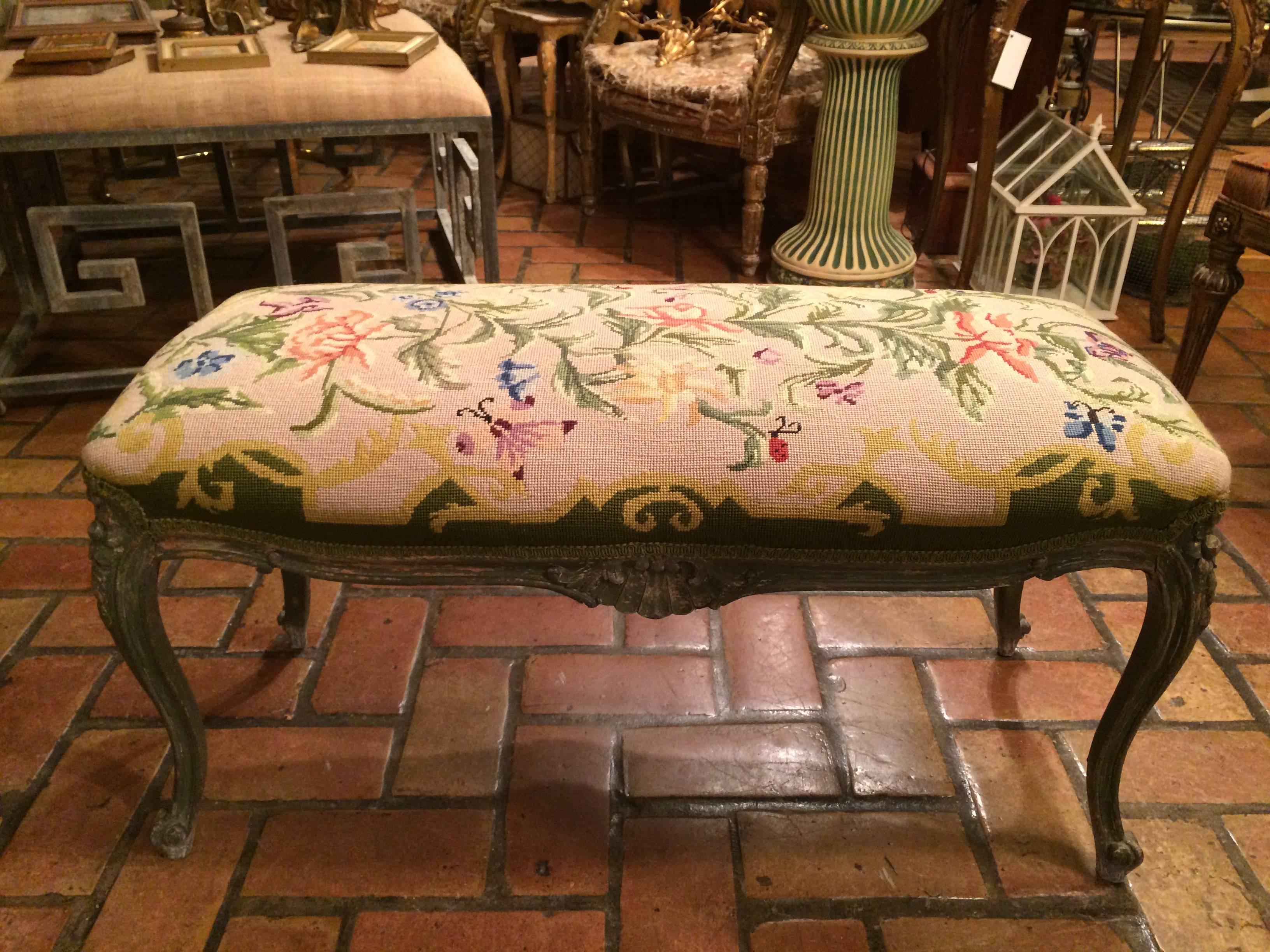 French style Aubusson needlepoint bench. Whimsical intricate design includes butterflies, ladybugs and flowers. Extremely feminine and delicate the colors in this are phenomenal. Ideal for a child's room. This item will parcel ship for about