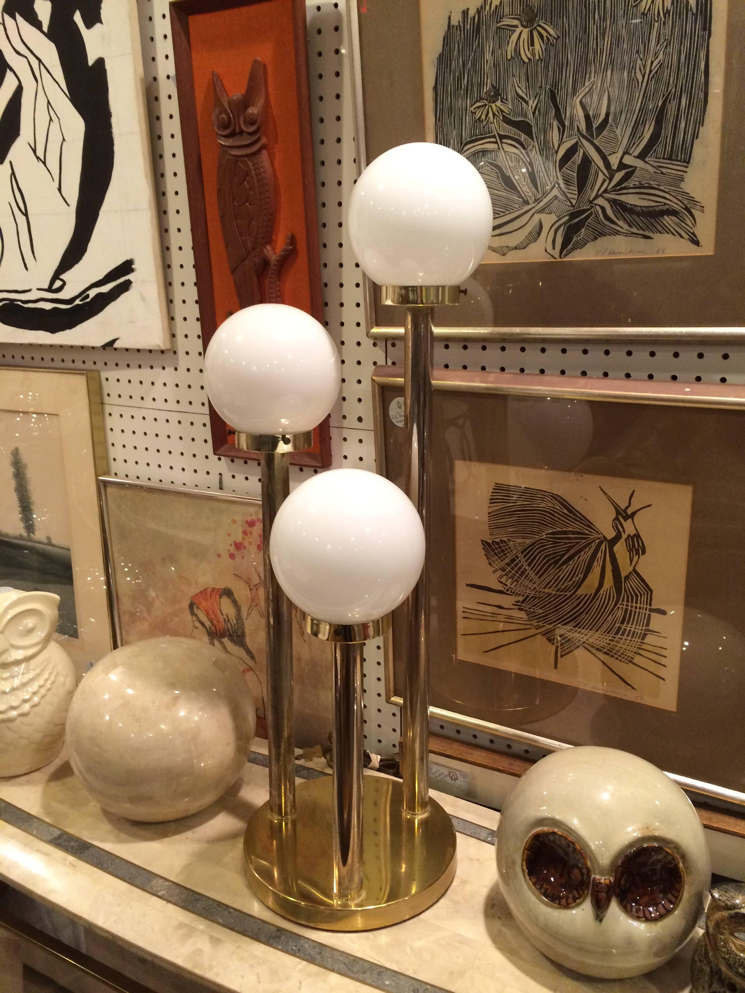 Robert Sonneman style lollipop table lamp in brass. This tripod has three settings to light your room.