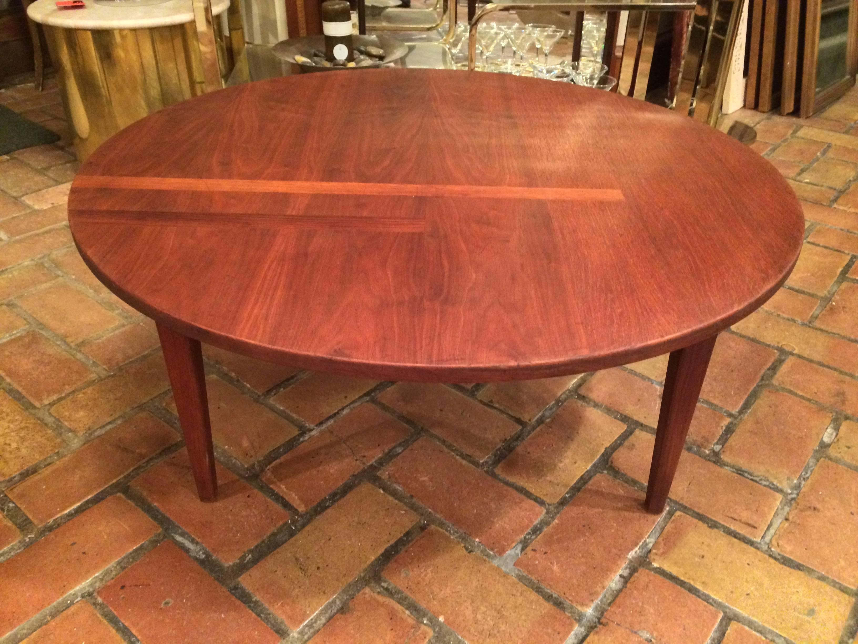 Mid-Century round solid walnut coffee table. This table is a beauty with its rich honey tones and gorgeous inlaid lines.