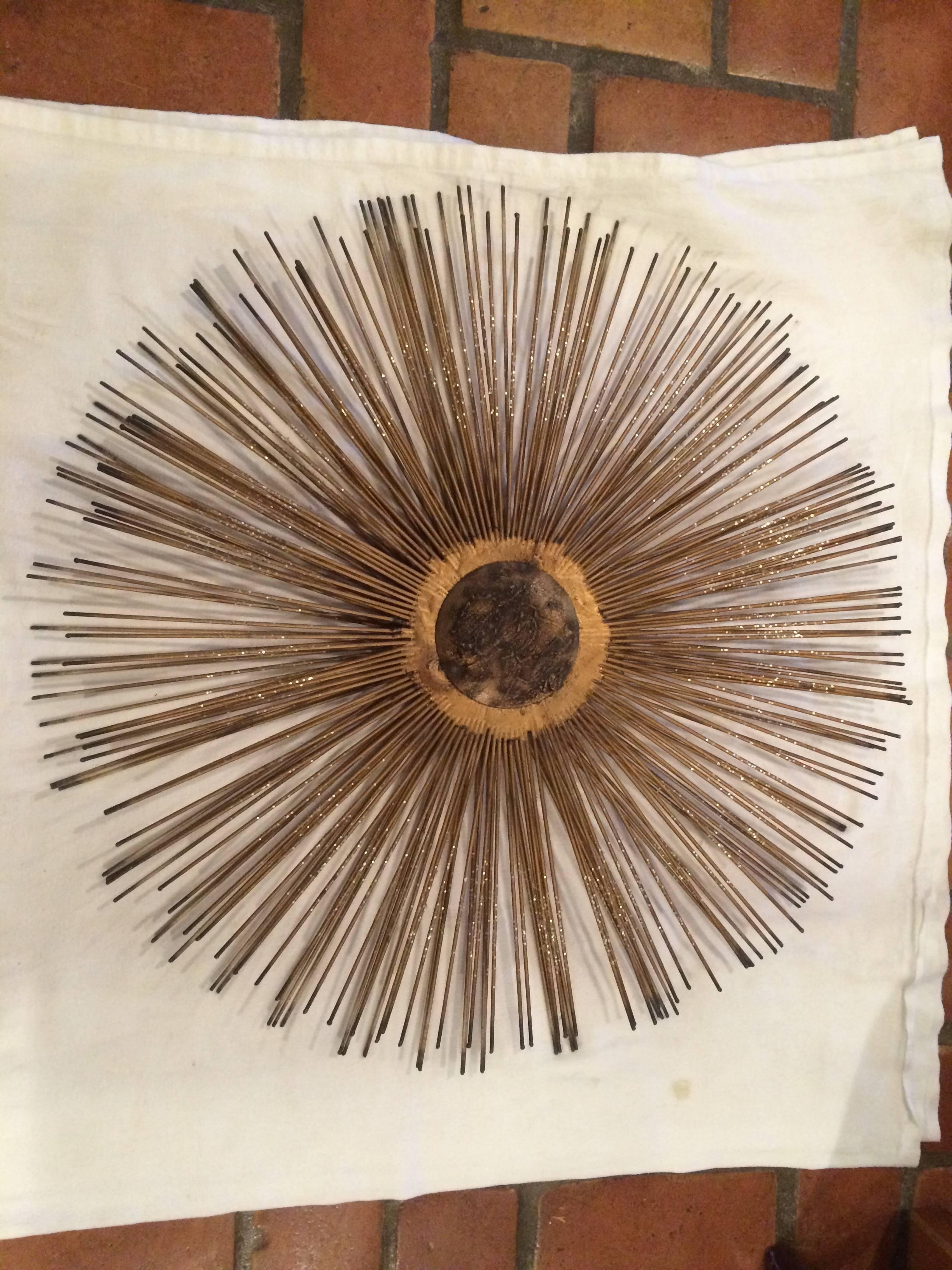 Mid Century Brutalist Starburst Wall Sculpture. Iconic design ideal for that living room wall or bedroom accent piece. In the manner of Curtis Jere or William Friedle. Hand made in the 1960's of iron and metals. The center medallion is solid iron