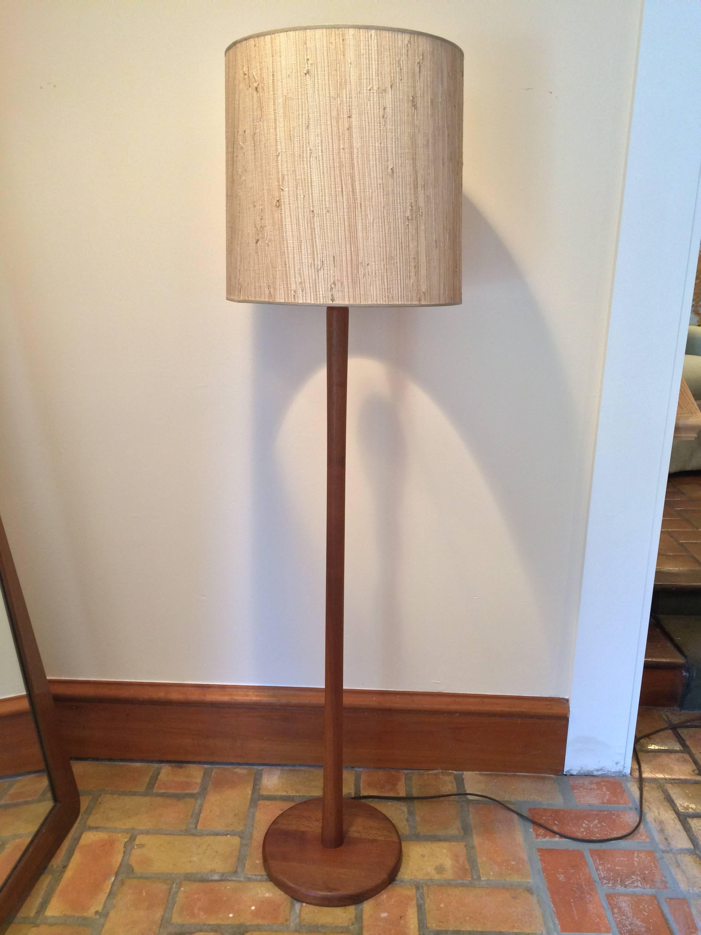 Mid-Century Modern walnut floor lamp designed by Jane and Gordon Martz for Marshall Studios with original grass-cloth lamp shade. This piece is in Immaculate condition and would complement any Mid-Century room be it office or living room. It