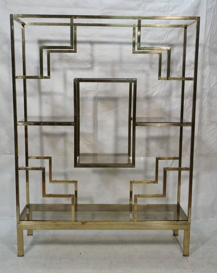 Large geometric brass tone etagere wall display unit with smoked glass shelves. Attributed to Romeo Rega. More photos to come. Marked Italy on bottom.
 