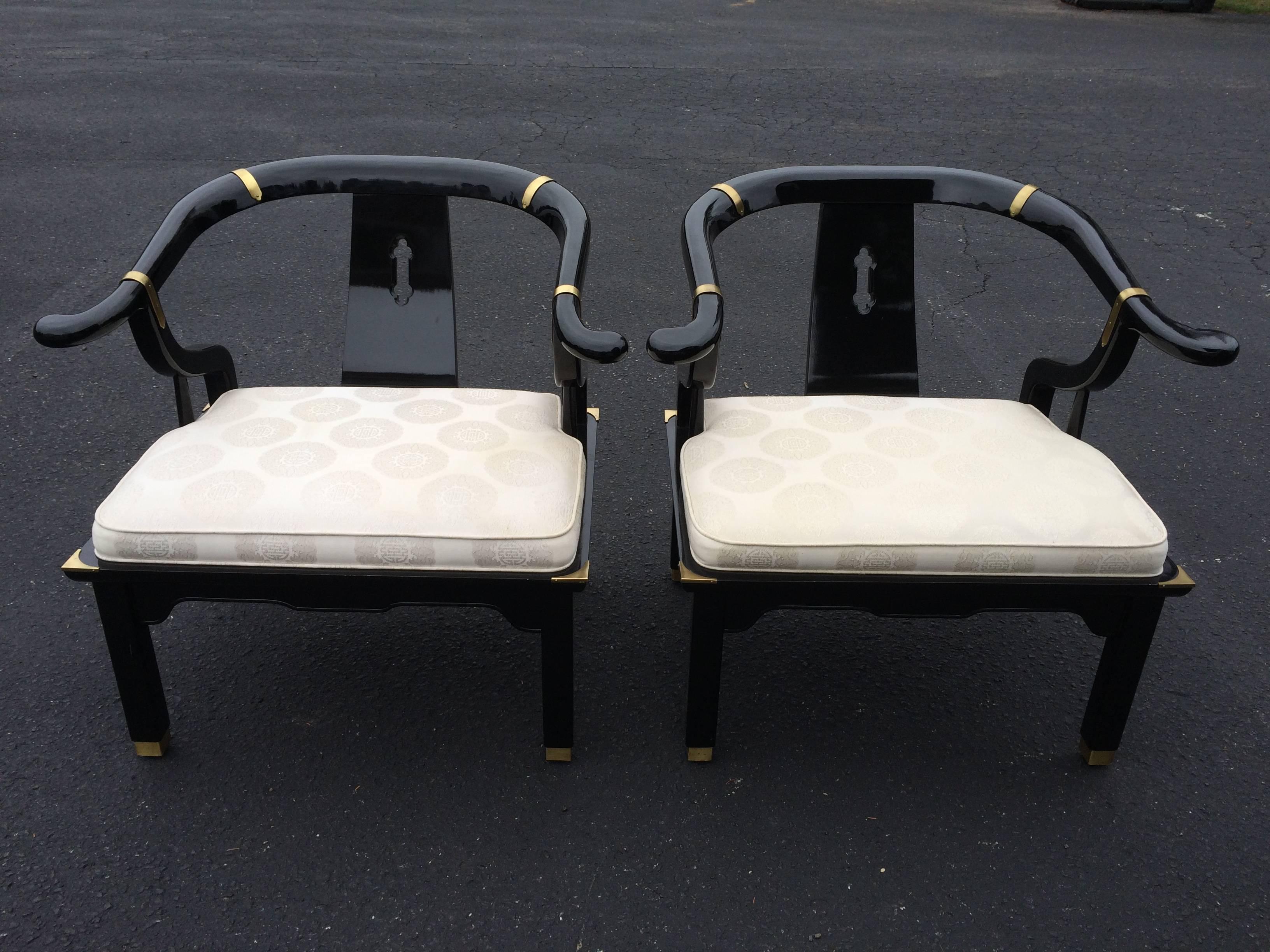 Original condition Pair of Century Asian black lacquered and brass chairs.  Style of James Mont
 Beautiful detail and design to this iconic pair of chairs. Some wear to lacquer on chair back
Ivory damask seat upholstery. 29.5 in.Hx31 in.W x 25 in.D.