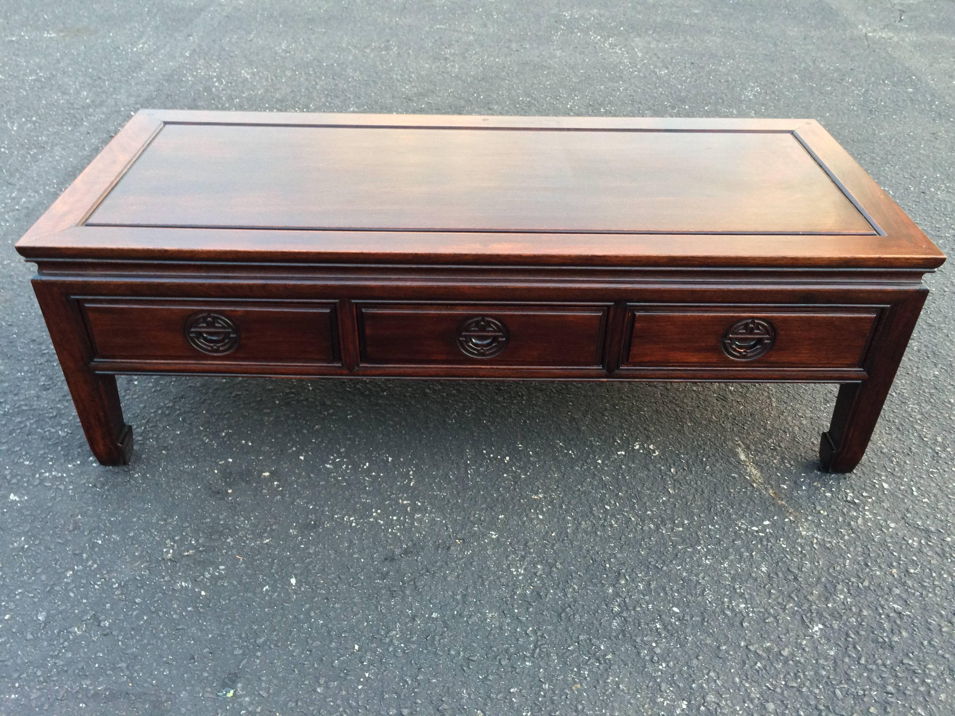 Antique Chinese Chippendale rosewood coffee table. With three drawers with heavily carved handles.Some sun fading of finish to table top since being in our store.