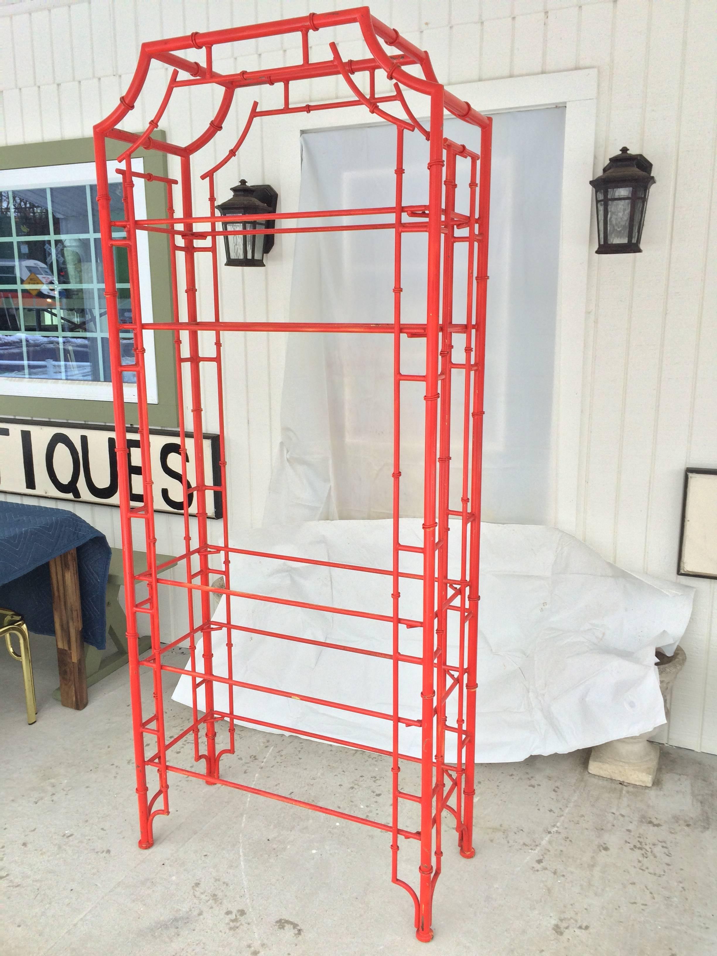 Chinese Chippendale pagoda faux bamboo iron etagere in fire red. Solid well built piece. Has five clear glass shelves. Fabulous fire engine red color but can be sprayed any color you desire. Silver gray or white,etc. It measures: 81 High x 34 w x 14