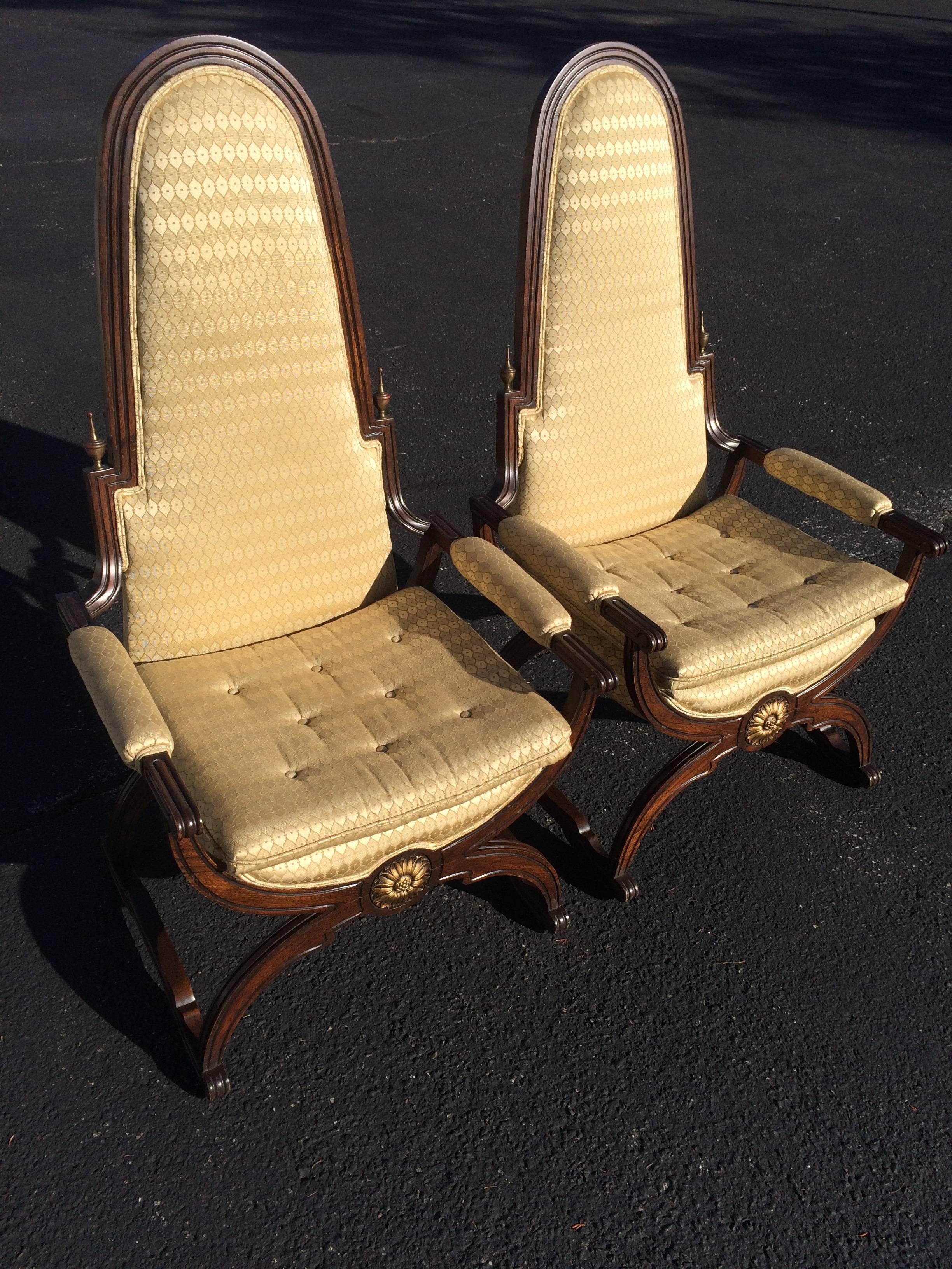 Pair of Hollywood Regency throne chairs. These popular X-based chairs come with their original, clean upholstery. Chairs are a bit light and somewhat wobbly but gorgeous to look at and can probably be reinforced. We believe the gilded finials are