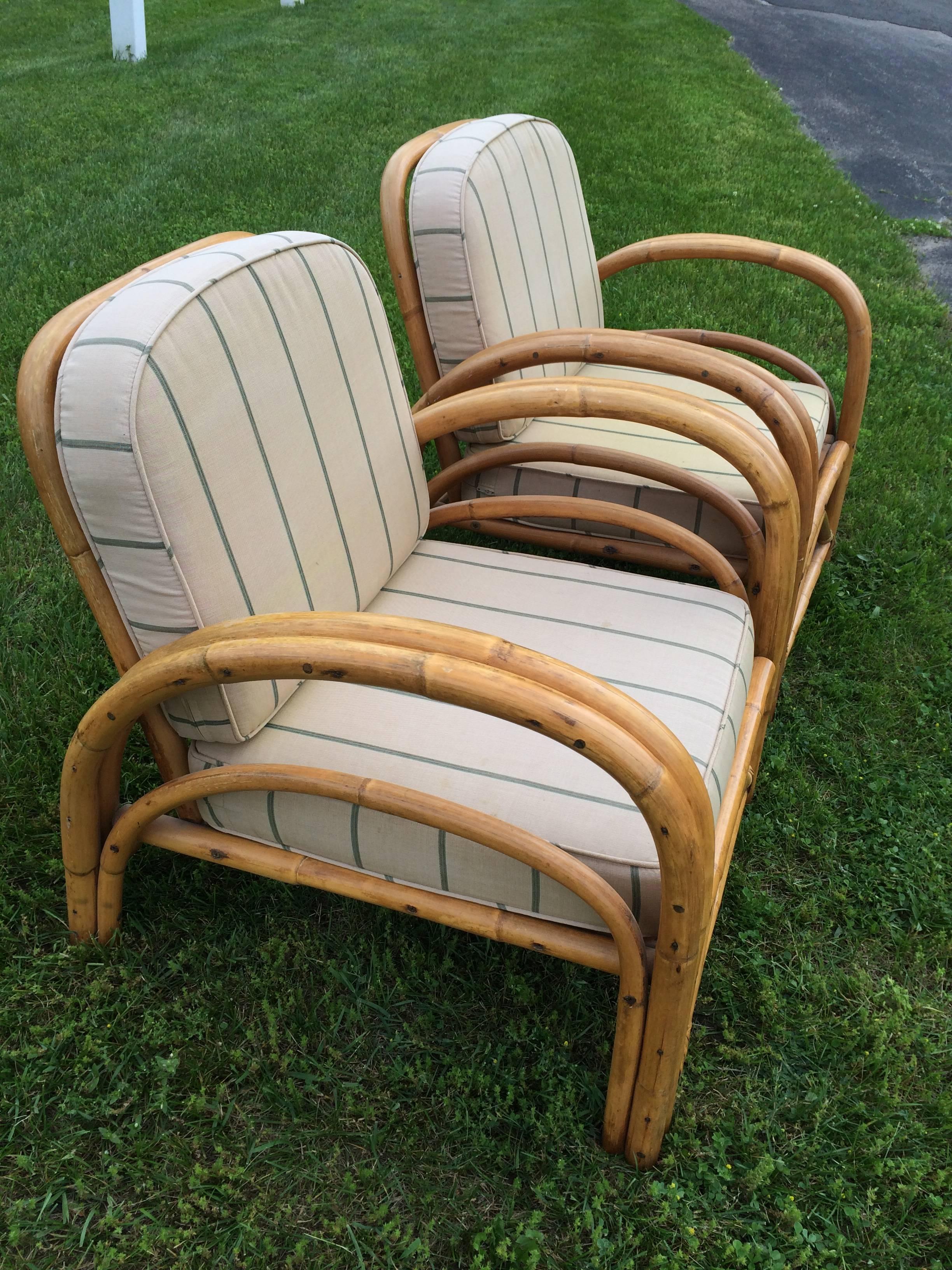 Pair of Rattan Lounge Chairs in the style of Paul Frankl . Classic styling make these chairs timeless . They have practical function as well as beauty. Perfect for that covered porch or screened in patio. Cushions are loose and in good shape. Some