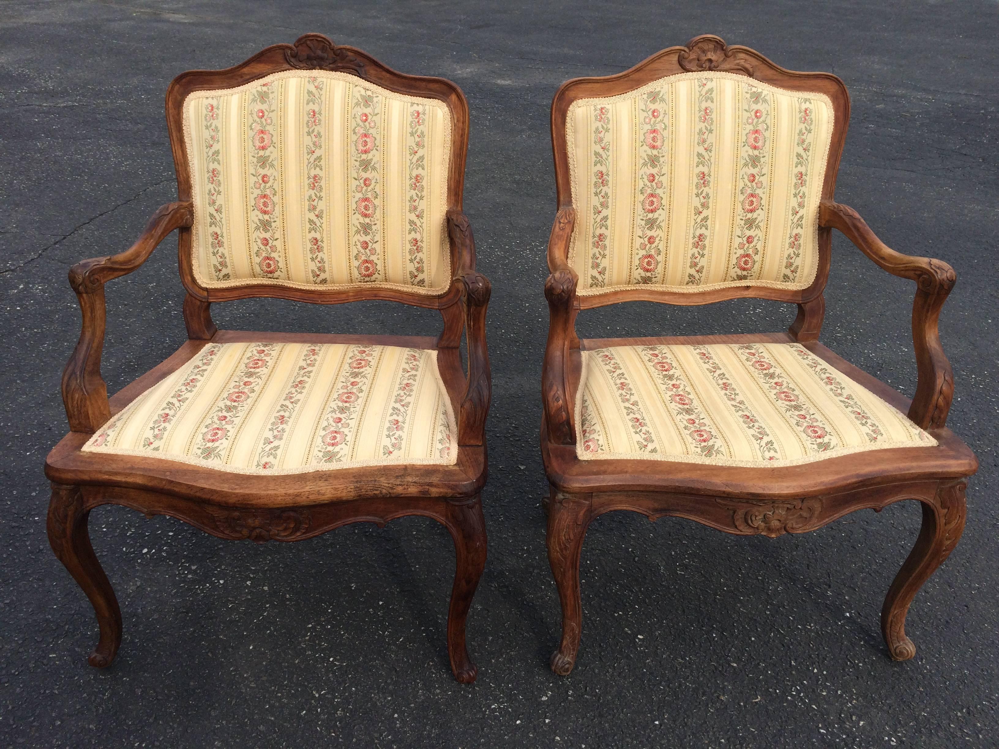 Pair of French Louis XV style armchairs. Nicely solid wooden carved pair with nice patina to the wood.
Upholstery in excellent condition. Clean and simple lines. These chairs will be a beautiful edition to any French country home. Solid sturdy