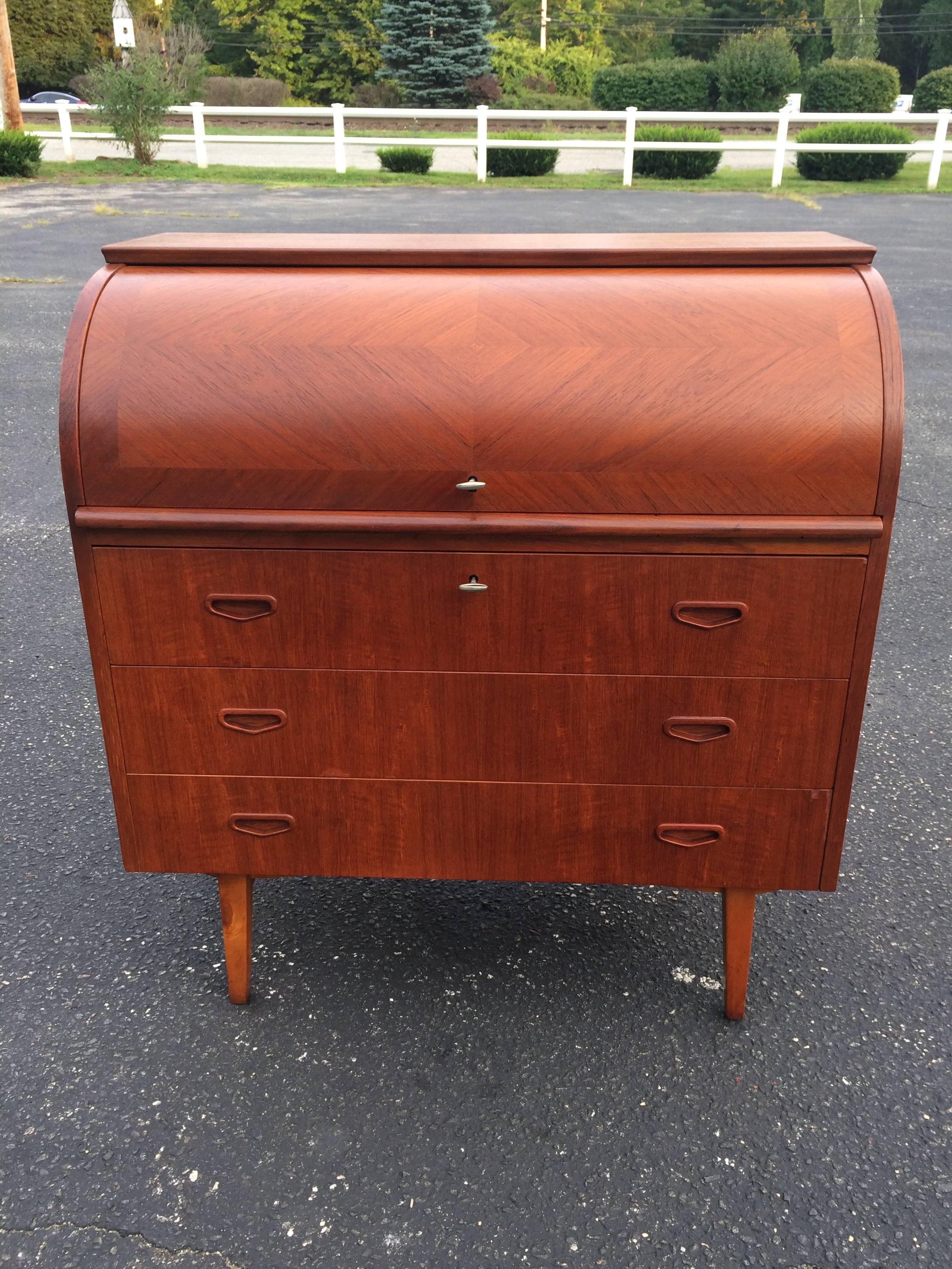 This desk is very practical desk with it's smart design and ample storage. Comes with two original keys to lock both the top compartment as well as the top drawer. Has a retractable writing base that pulls out from the interior once the cylindrical