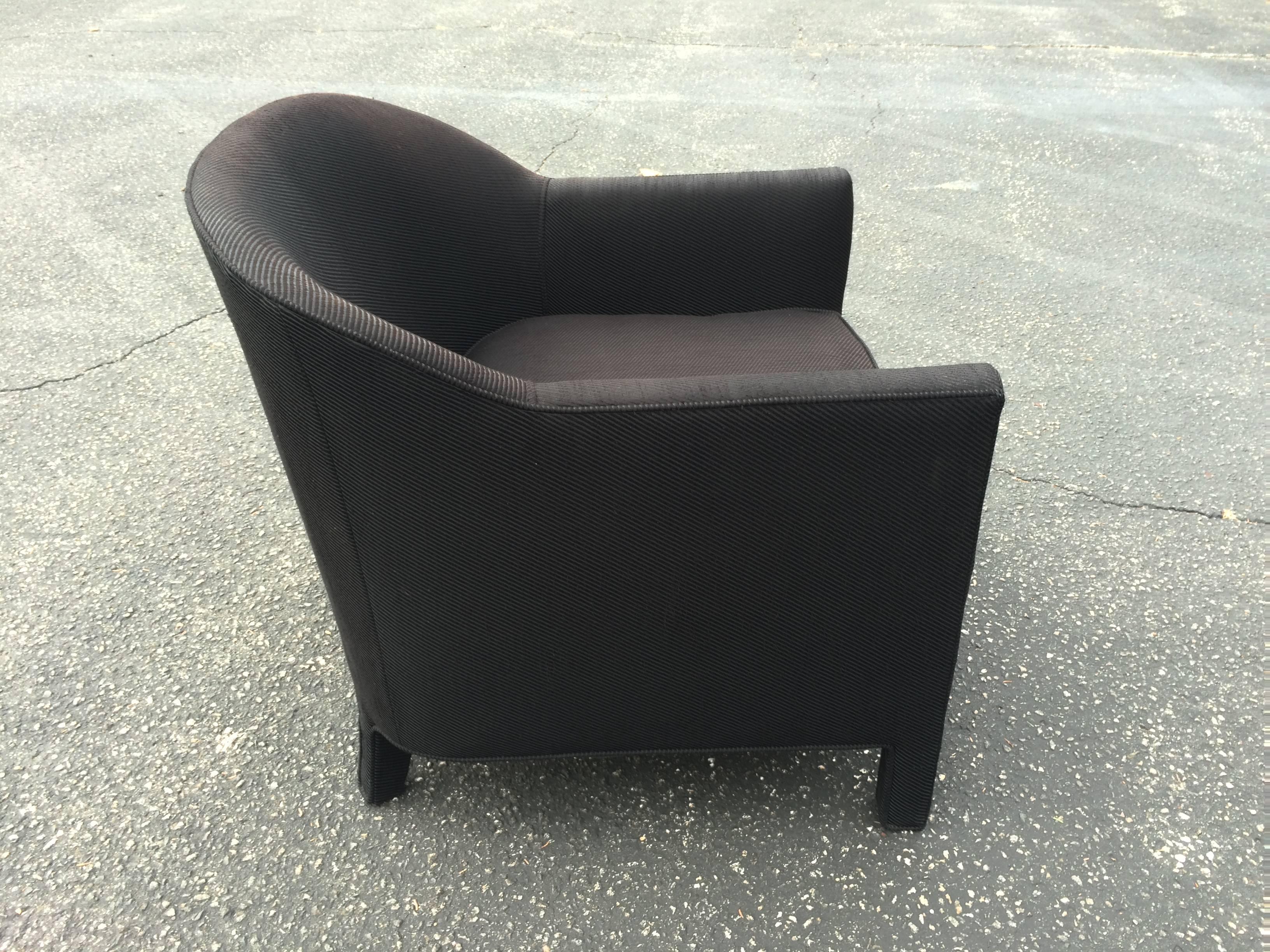 Black barrel back club chair in the style of Ward Bennett. High end construction. Down filled seat cushion. Fading to one side of chair from sun hence could use a re-upholstery . Great solid bones and shape. Comes with one tufted loose pillow.