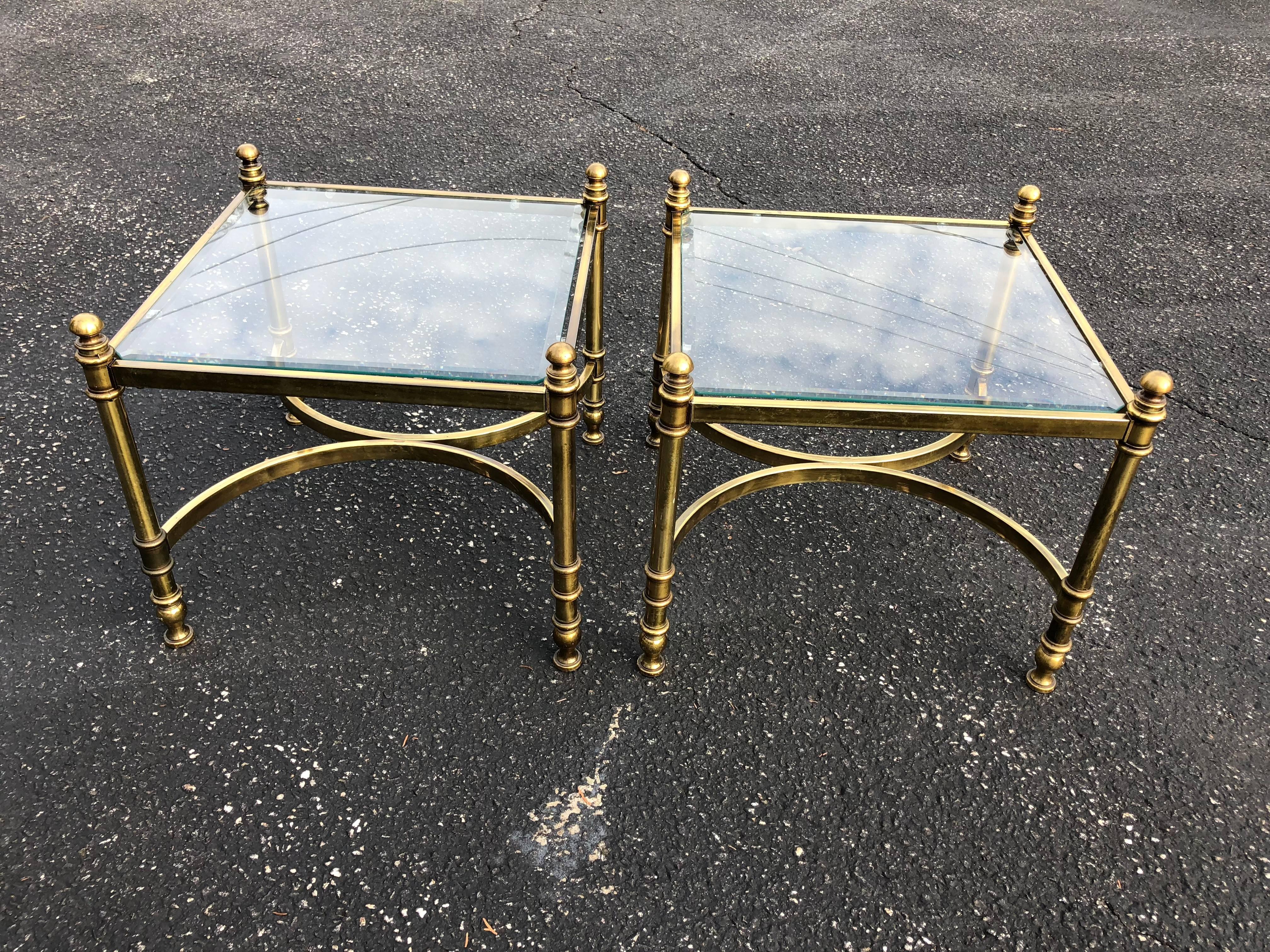 Pair of Hollywood Regency brass and glass end/coffee  tables. Glass tops are removable and have a nice one inch bevel all around. They are cut in a hexagonal pattern. Please request an accurate shipping quote from 1stdibs. Also would make a great